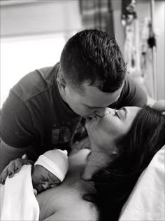 A tender black and white photograph captures an intimate moment between two people in a hospital room.