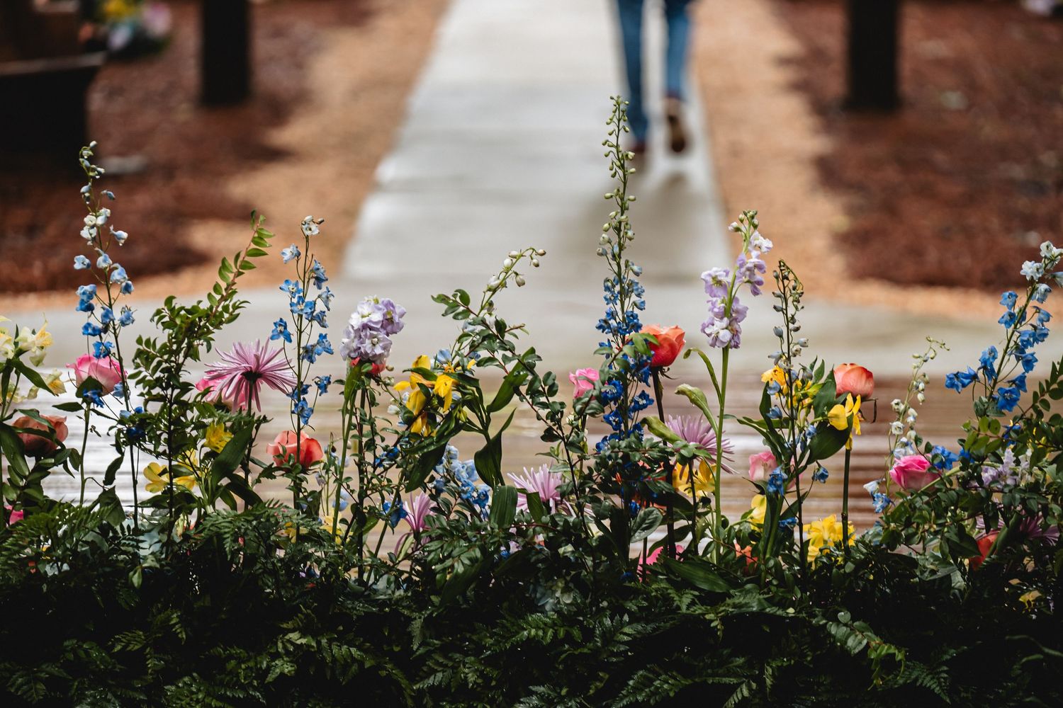 Colorful wedding flowers lining the ceremony space