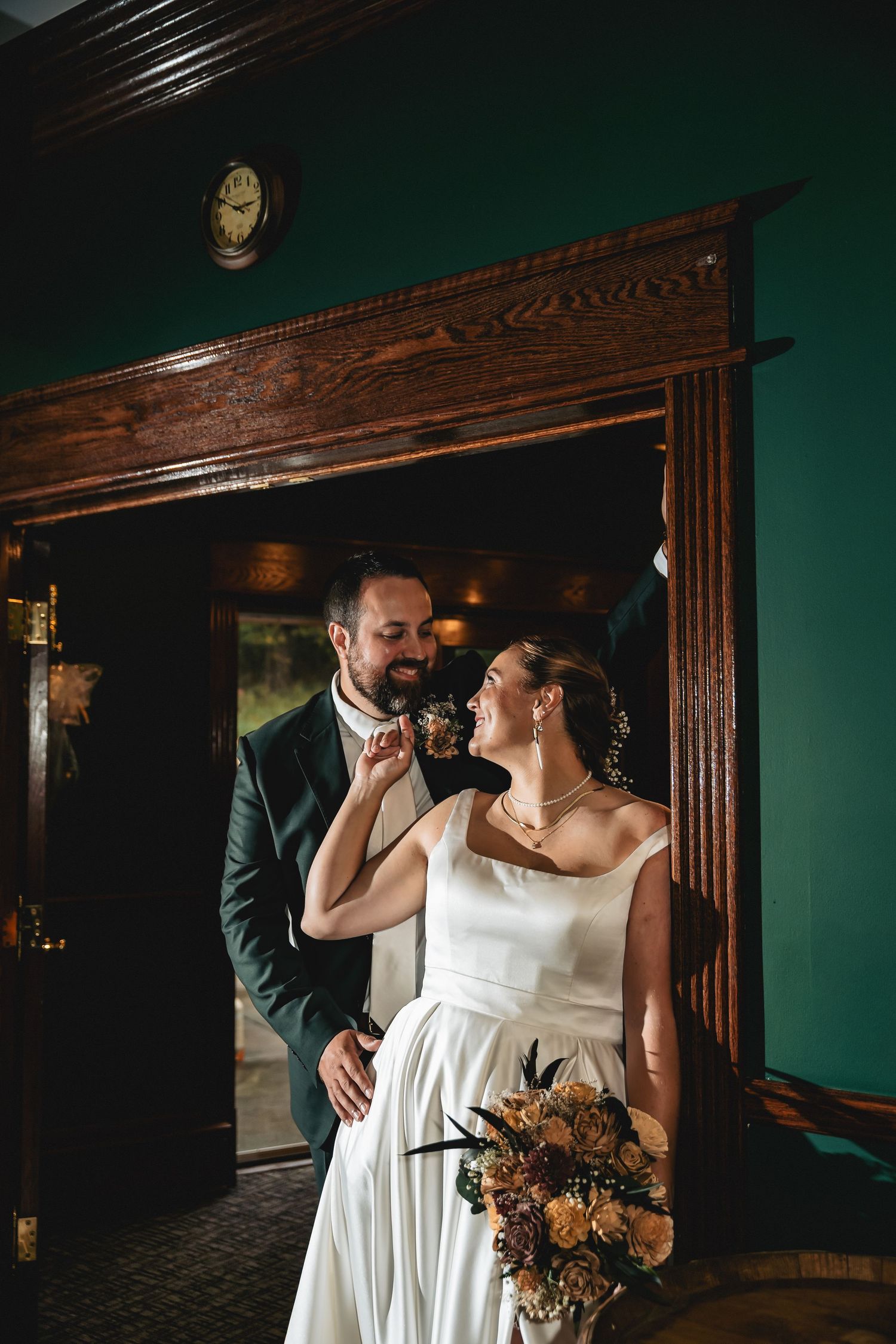 A couple shares an intimate moment in a dimly lit room with dark wood paneling and vintage decor.