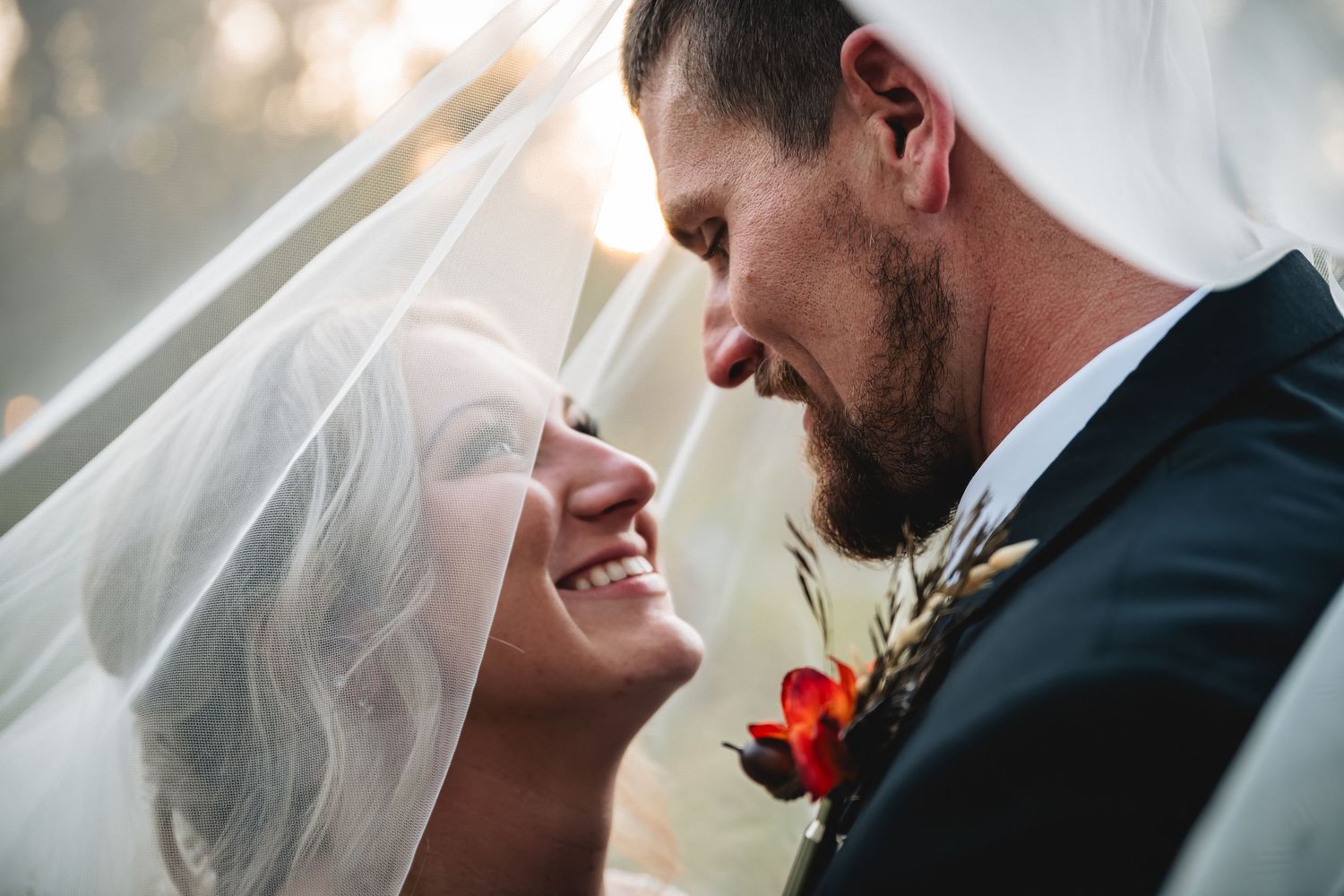 Romantic wedding couple in black and white share intimate moments during outdoor photo session.