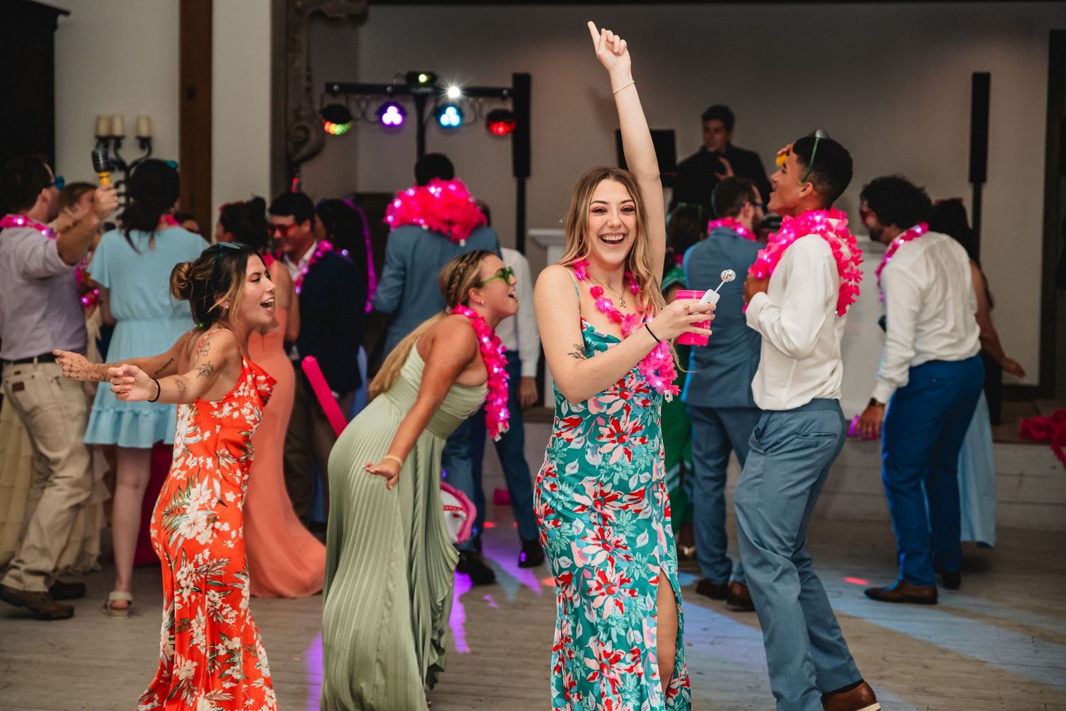 People dancing and socializing at a lively party or event with colorful outfits and festive atmosphere.