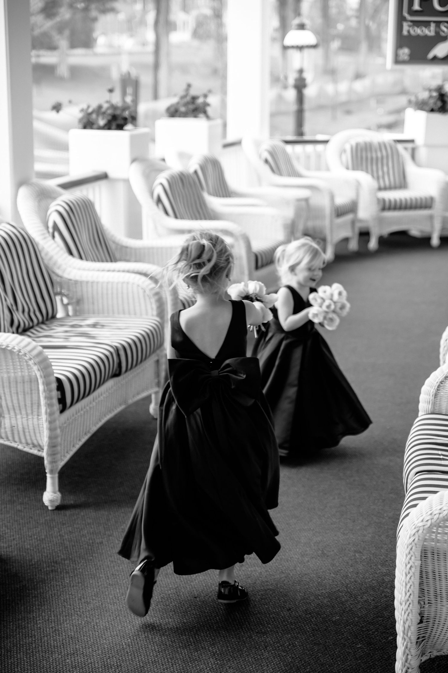 Black and white photo series showing elegant posed figures in flowy black clothing lounging on striped upholstered furniture.