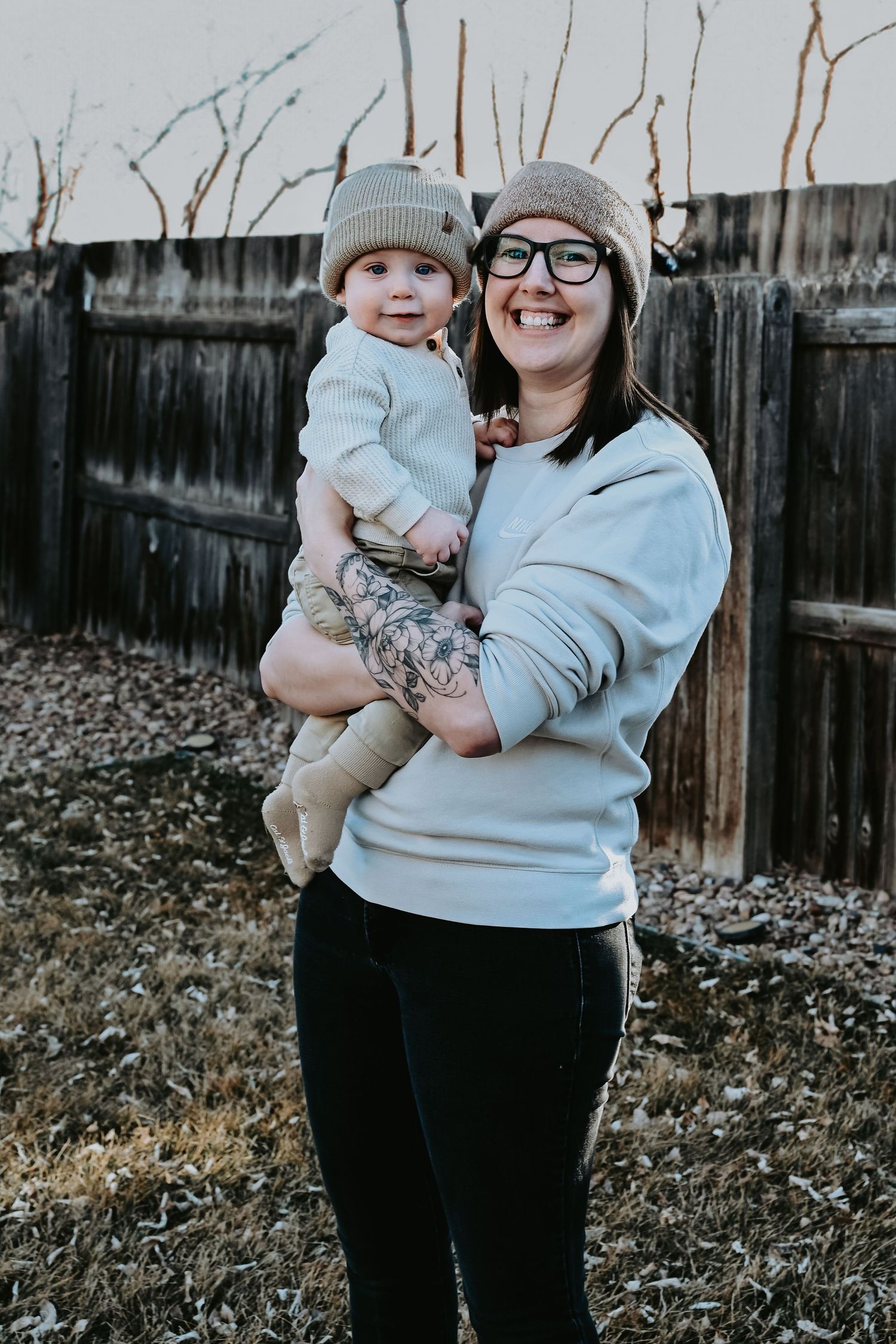 Mother holding baby son outdoor milestone session in Thornton, Colorado