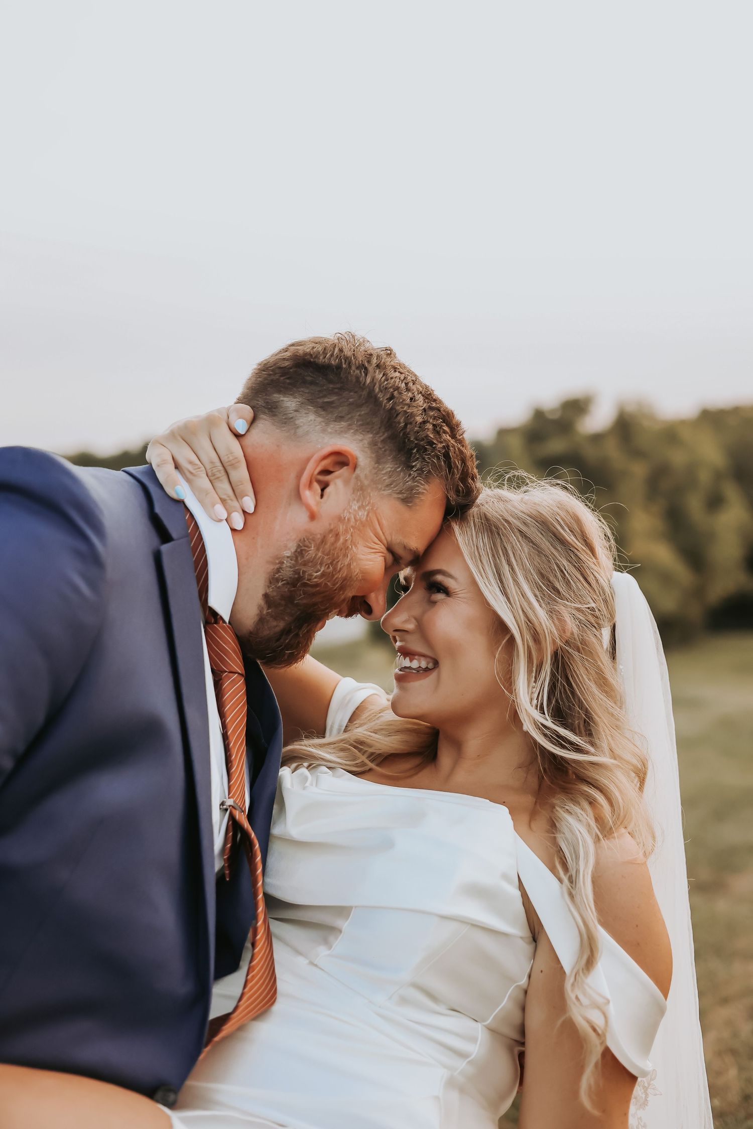 Close up of couple sharing tender moment during outdoor wedding portraits.