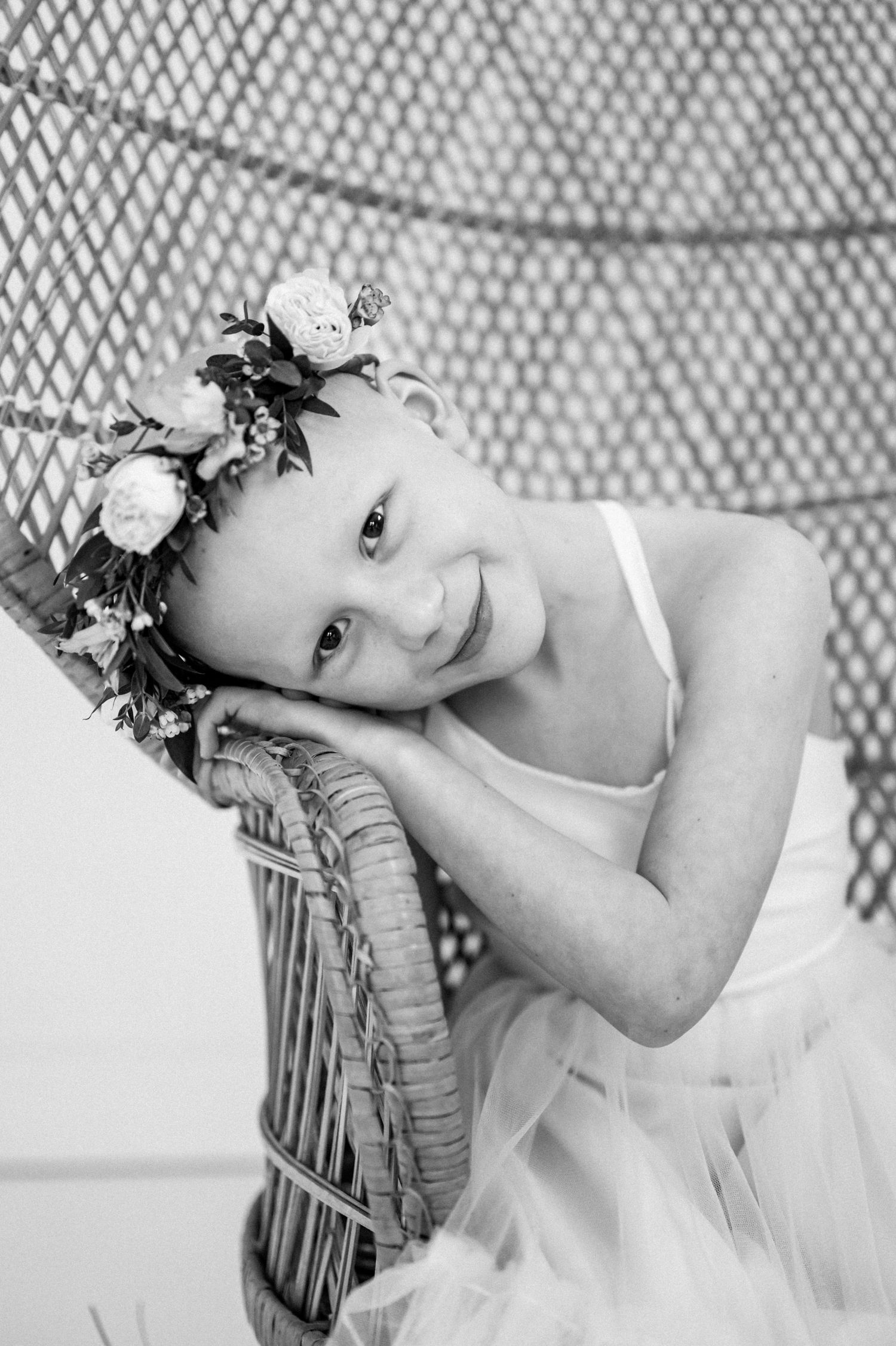 A series of black and white artistic portraits showing a dreamy pose against a textured lattice background.