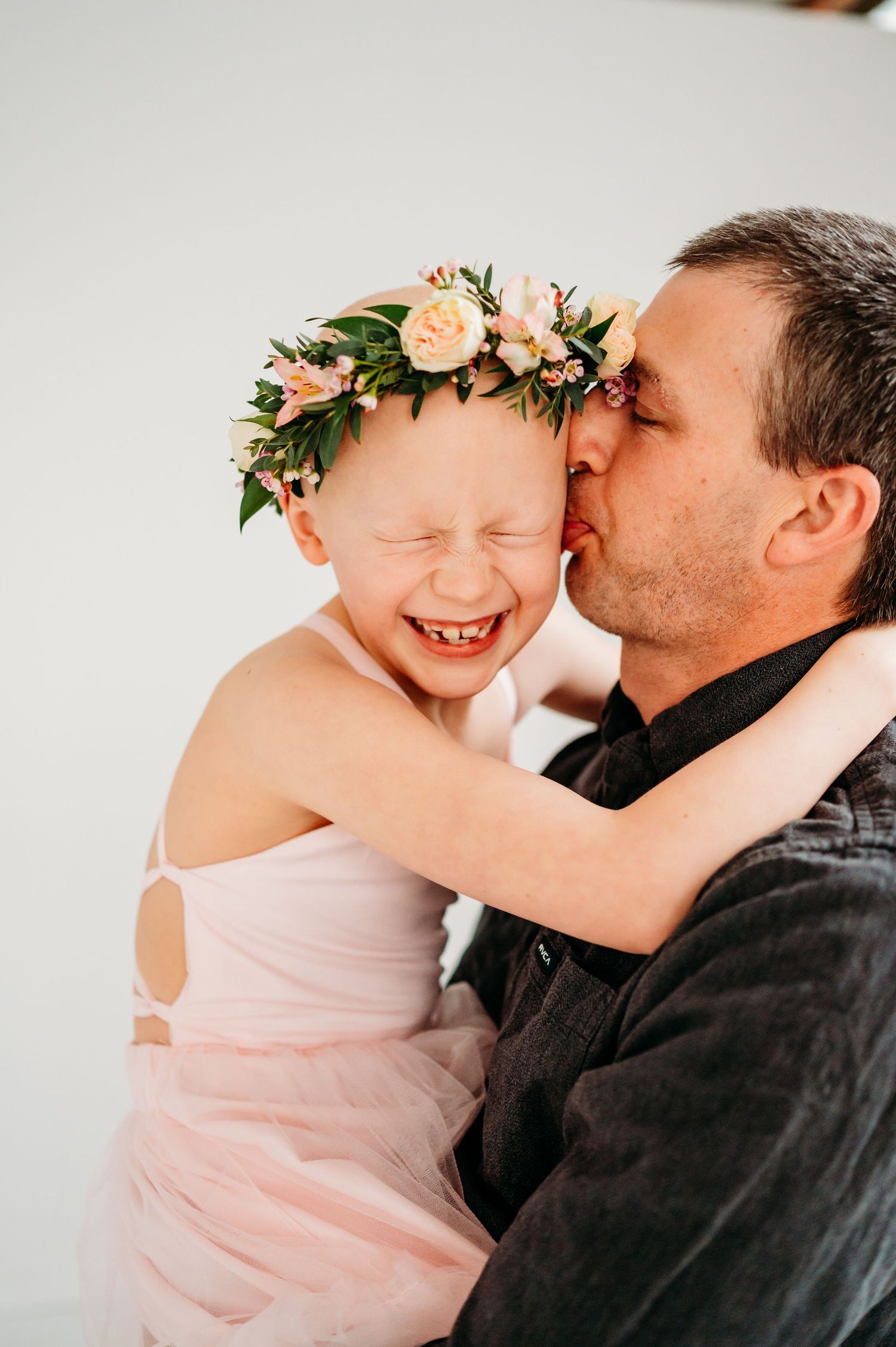 A sweet moment captured in a series of candid photos showing affection and laughter with floral crown details.