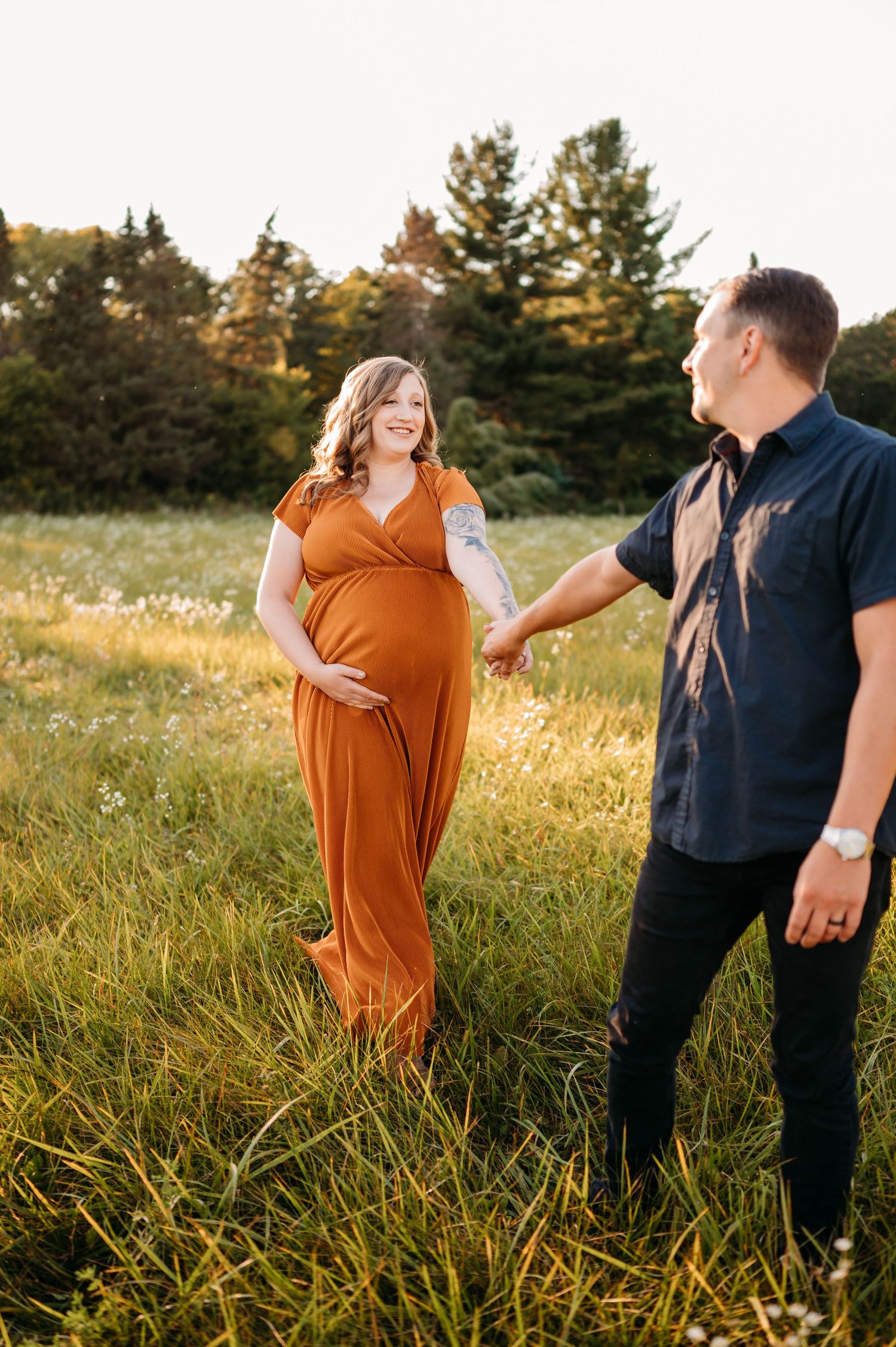 Couple in autumn field share tender moments in warm golden light during progression of loving embrace.