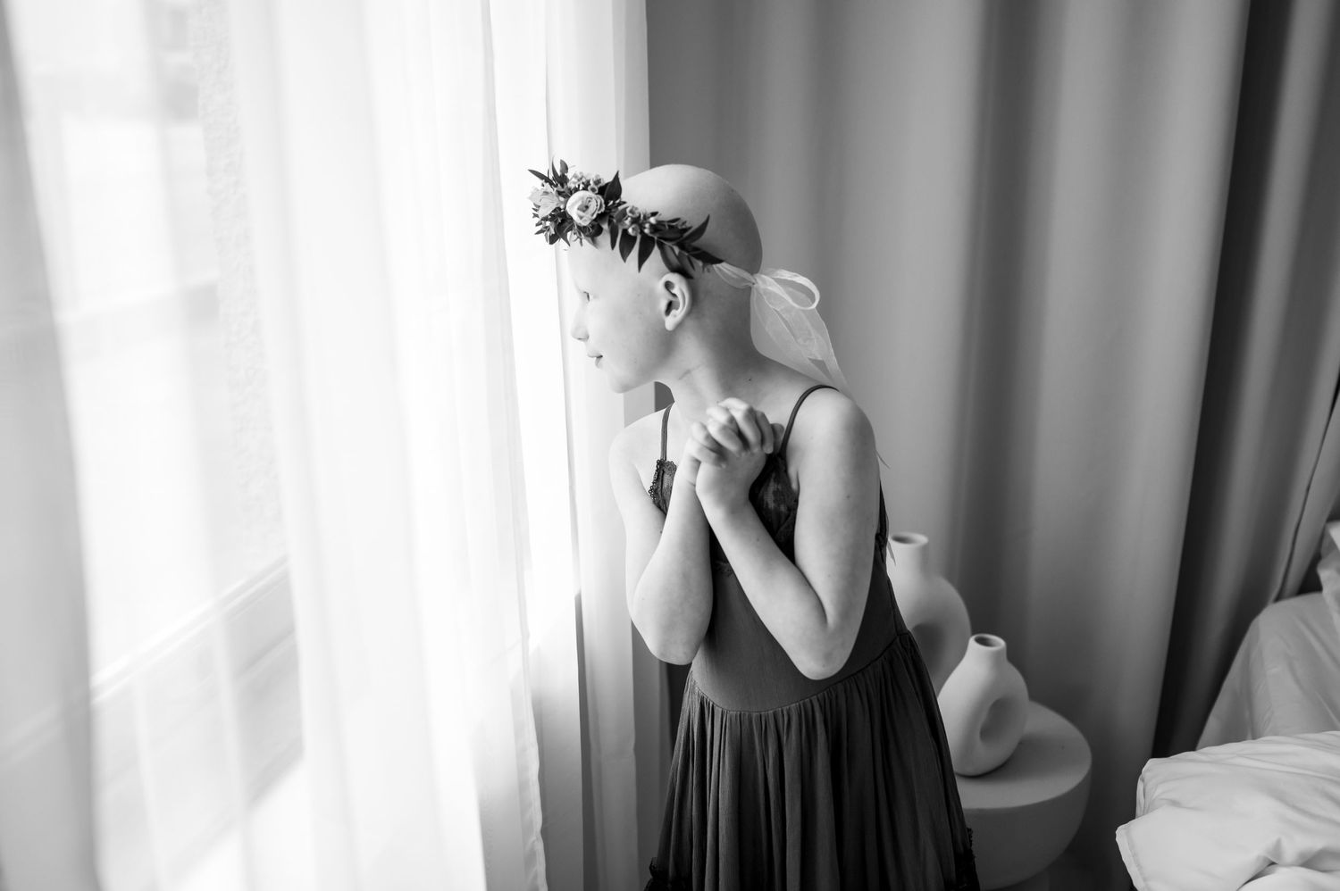 A series of black and white photos arranged in a filmstrip style showing a figure near a window.