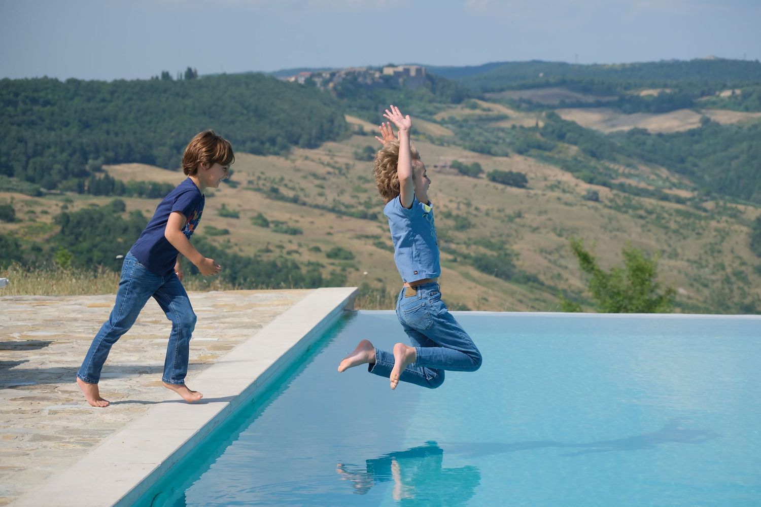 “Joyful family photography in Italy capturing playful, natural moments with parents and children in Umbria and Tuscany.”
