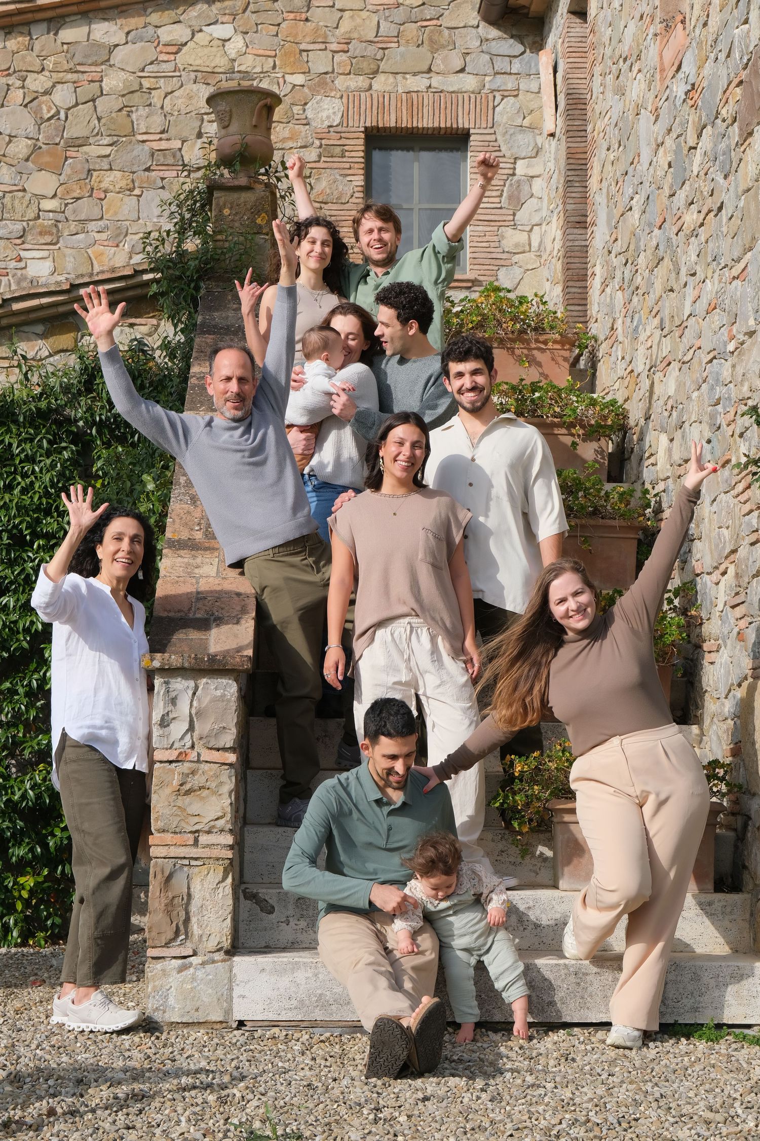 “Fun and relaxed family portrait in Italy with kids and parents enjoying authentic moments in Umbria and Tuscany.”