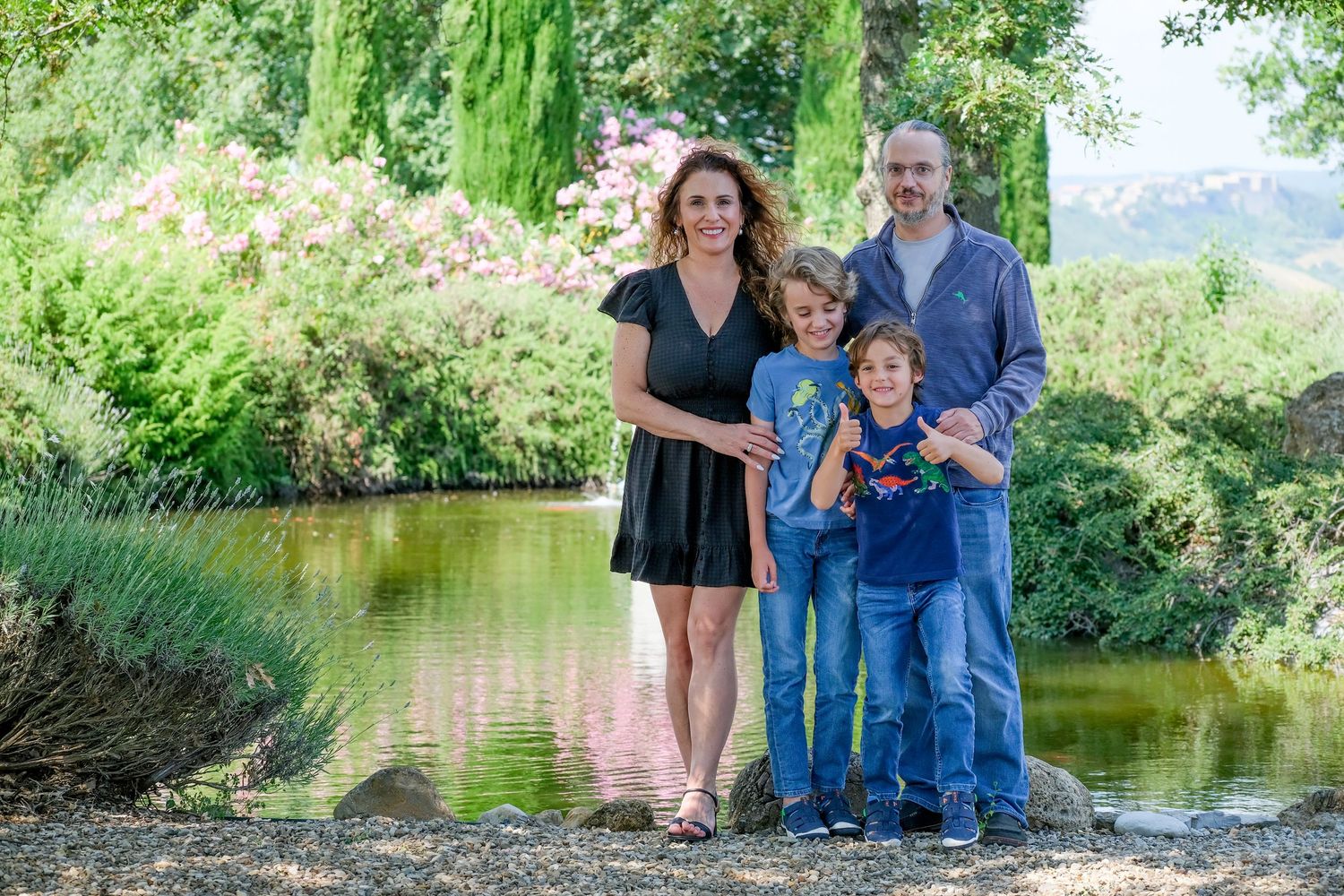 “Fun and relaxed family portrait in Italy with kids and parents enjoying authentic moments in Umbria and Tuscany.”