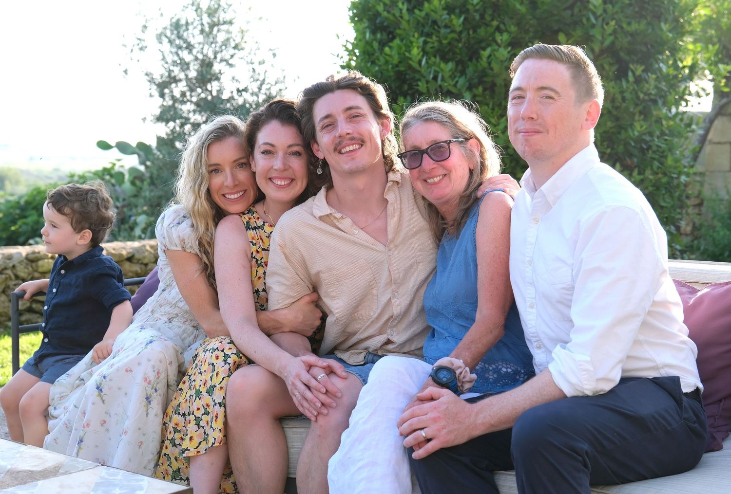 “Relaxed and fun family portrait in Puglia capturing genuine smiles and playful moments.”