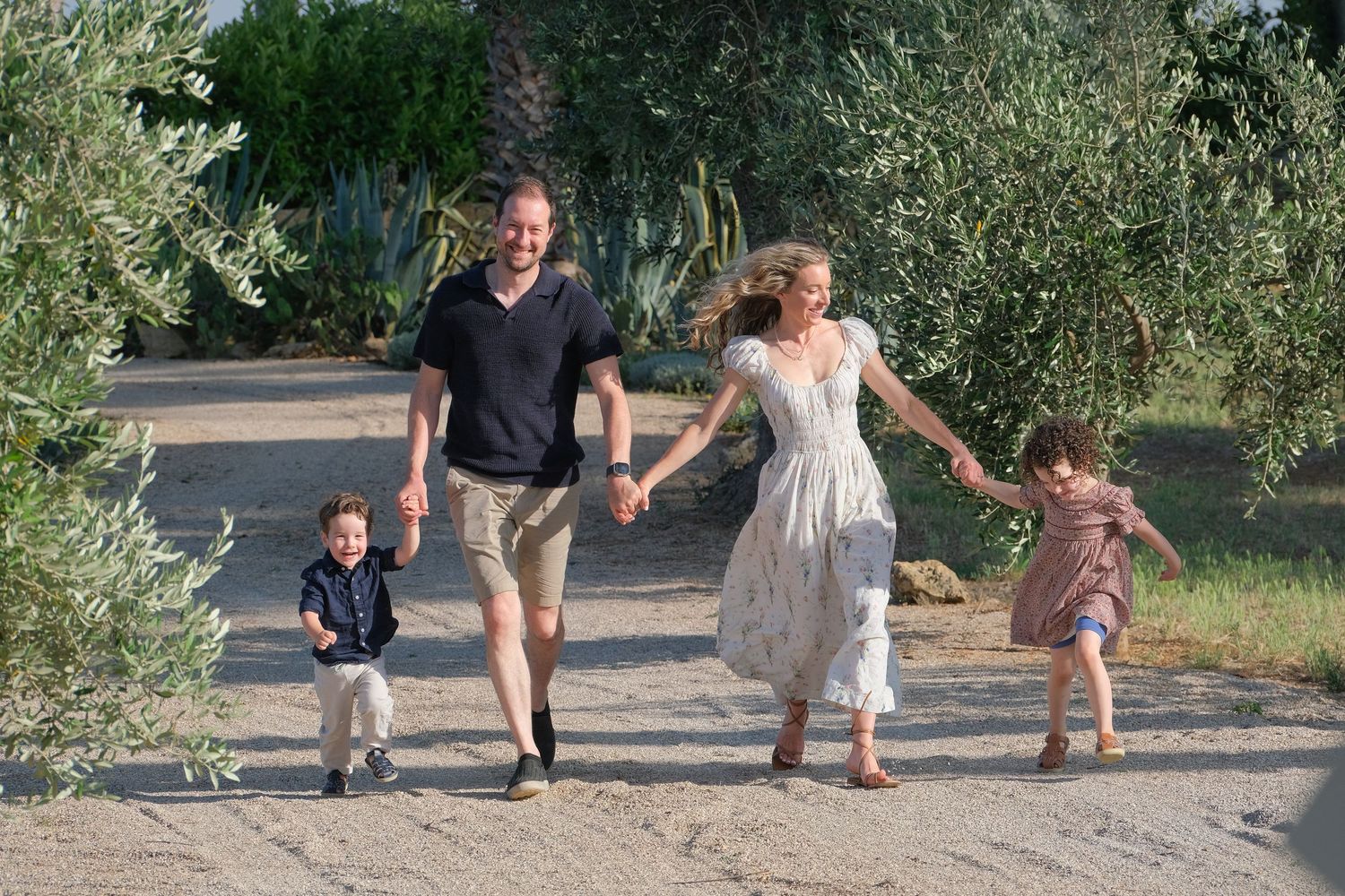 “Relaxed and fun family portrait in Puglia capturing genuine smiles and playful moments.”