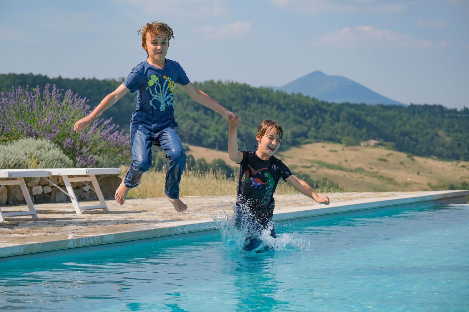 “Joyful family photography in Italy capturing playful, natural moments with parents and children in Umbria and Tuscany.”