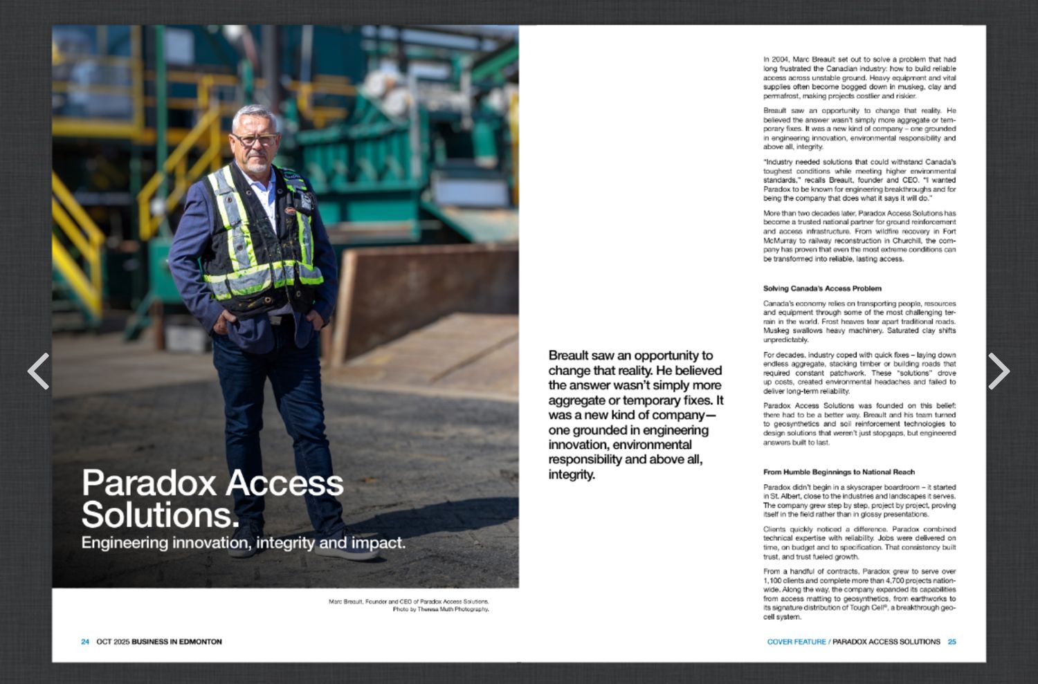 A worker in a safety vest and hard hat stands outdoors near industrial equipment for Paradox Access Solutions.