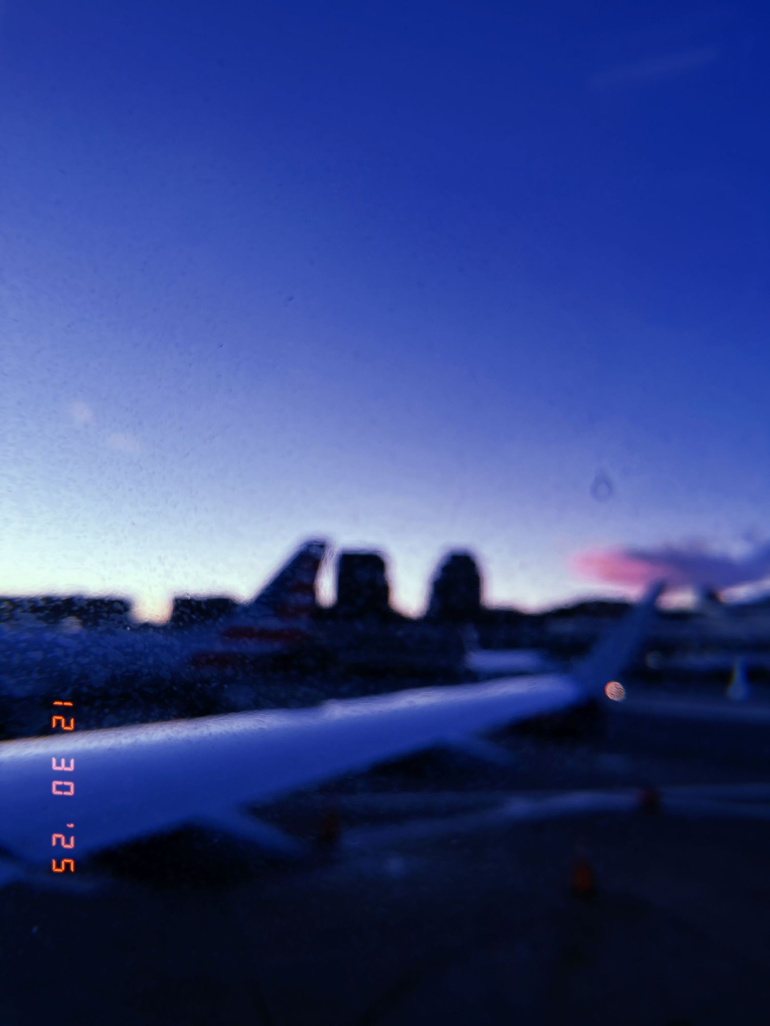 A sequence of sunset photos showing a dark silhouette of buildings against a deep blue twilight sky with time stamps.