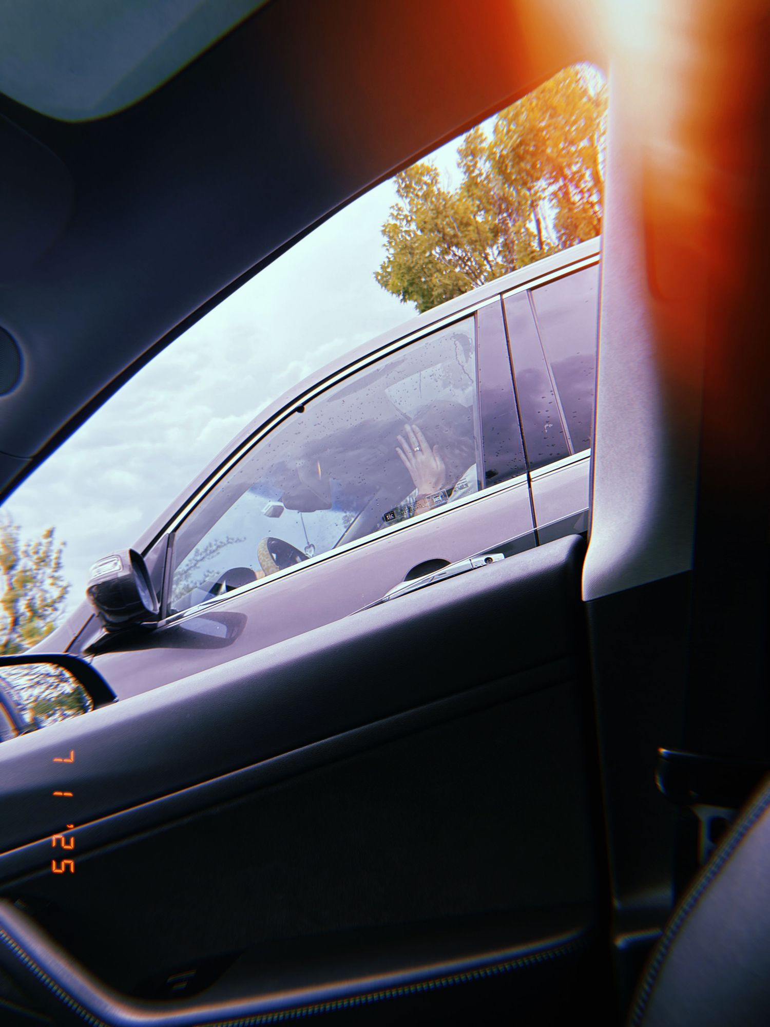 Multiple blurry sequential dashcam views showing a passing car at sunset through a windshield.