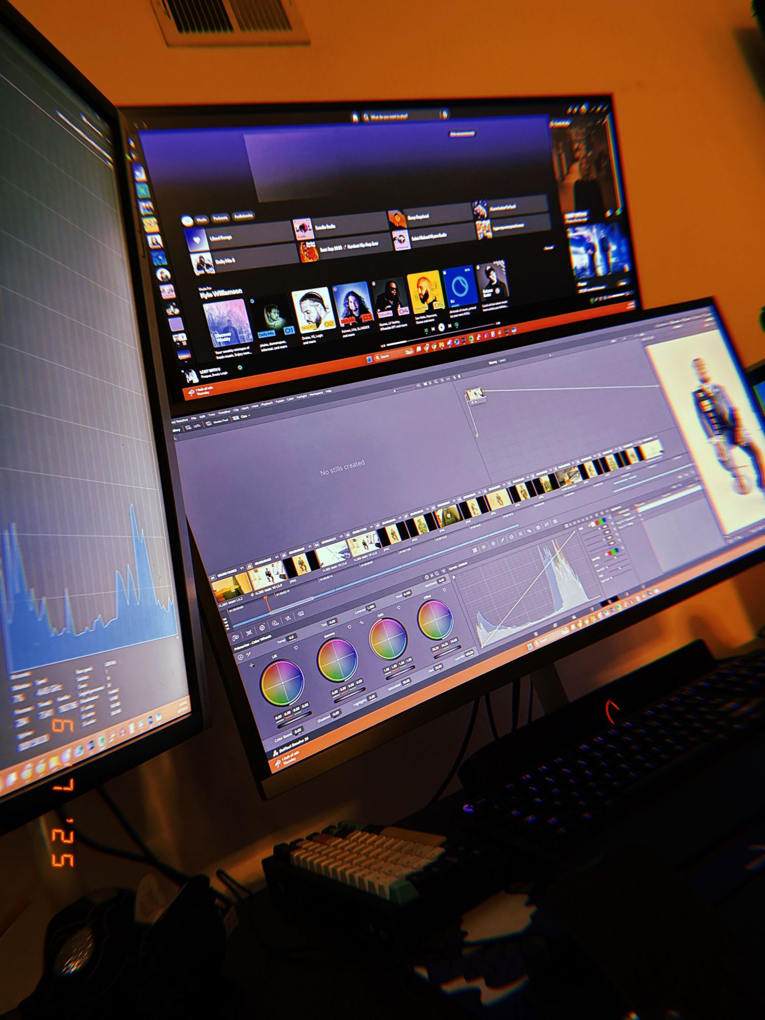 Multiple monitors displaying dark interface with colorful circular graphs and data visualizations on curved screens.