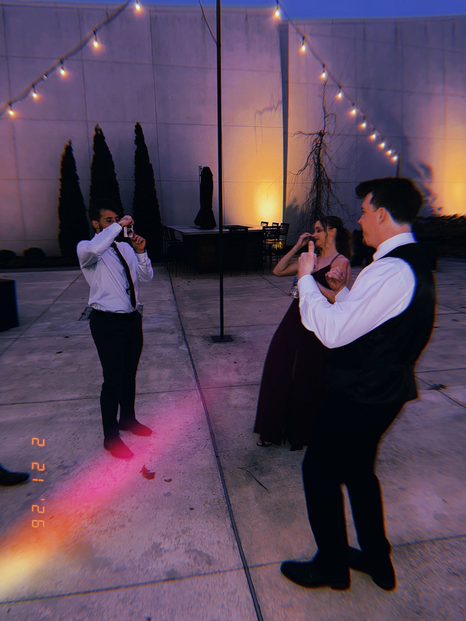 A sequence of photos shows two people dancing under string lights at dusk with colorful lighting effects on a rooftop.