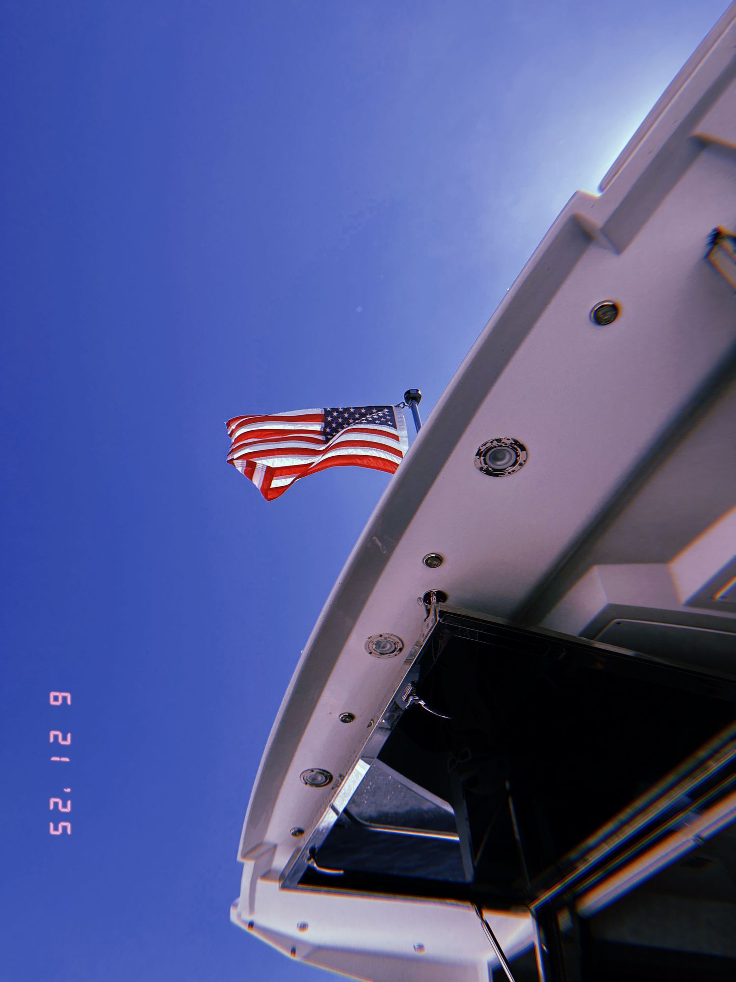 Sequence of photographs showing a graduated angle perspective of a white building exterior against a blue sky with an American flag.