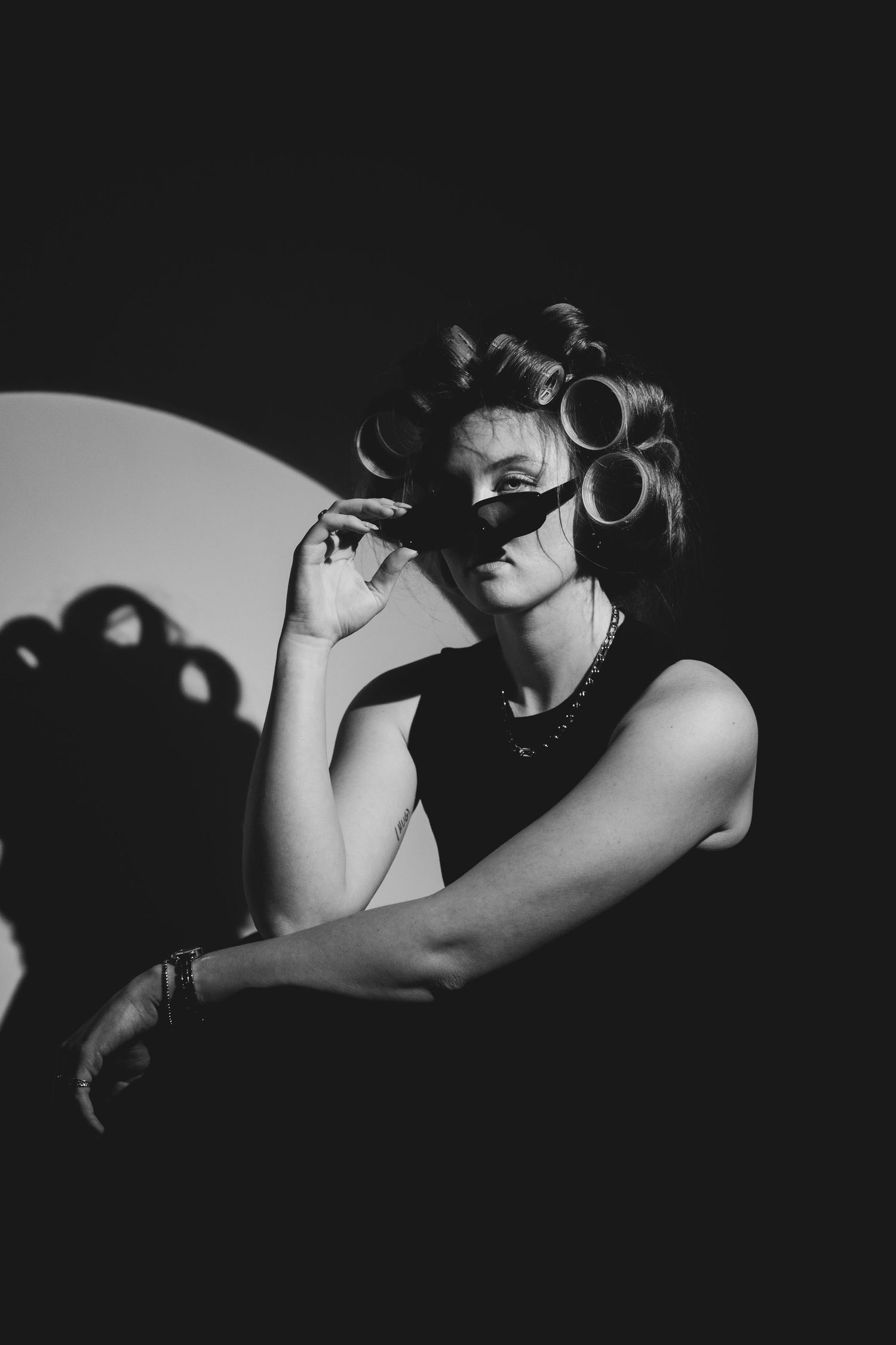 Dramatic black and white photo sequence showing a person in shadow with curled hair against dark background.