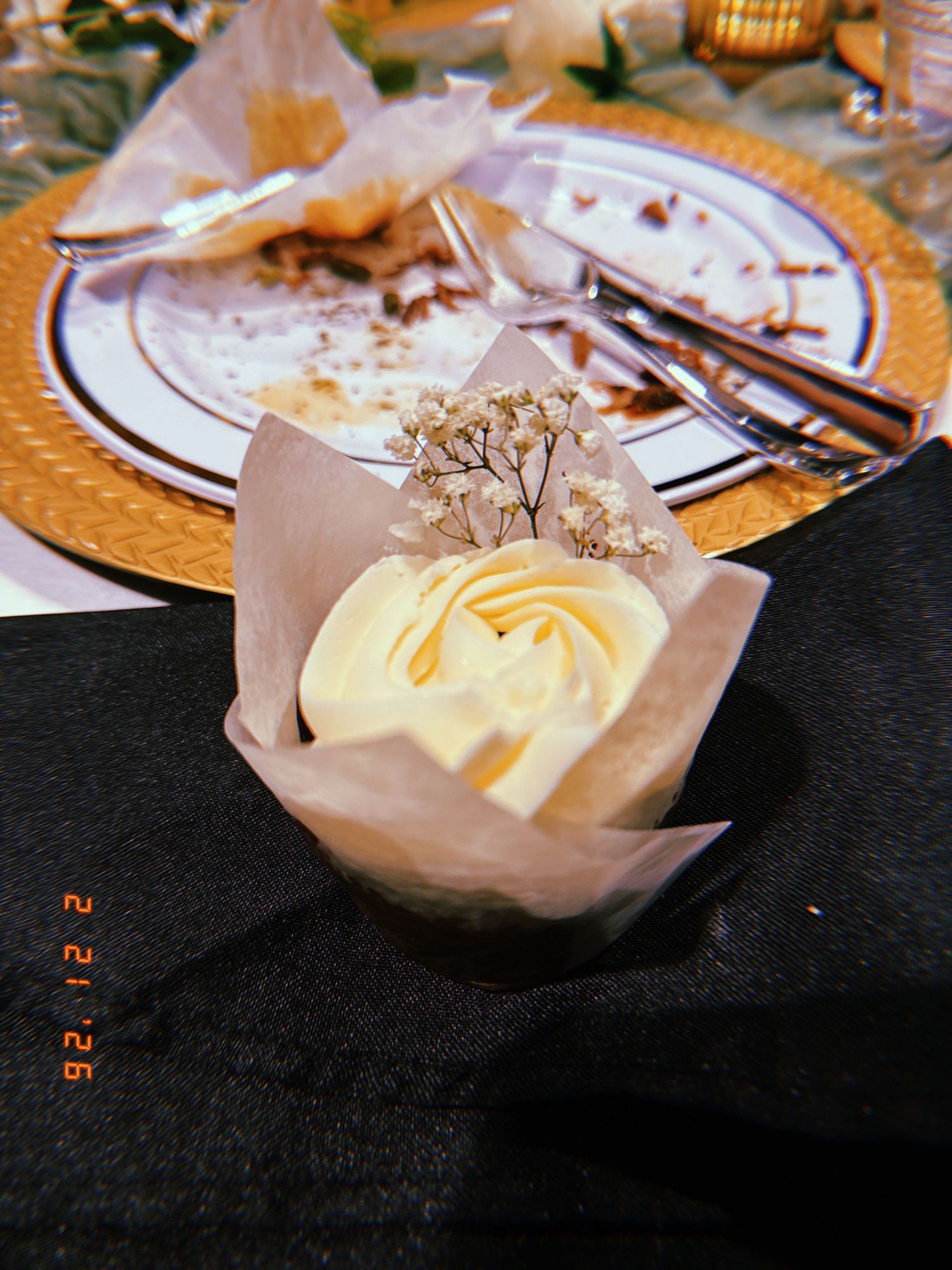 Four sequential photos showing a soft butter dessert served in parchment paper on a dark surface with decorative garnish.