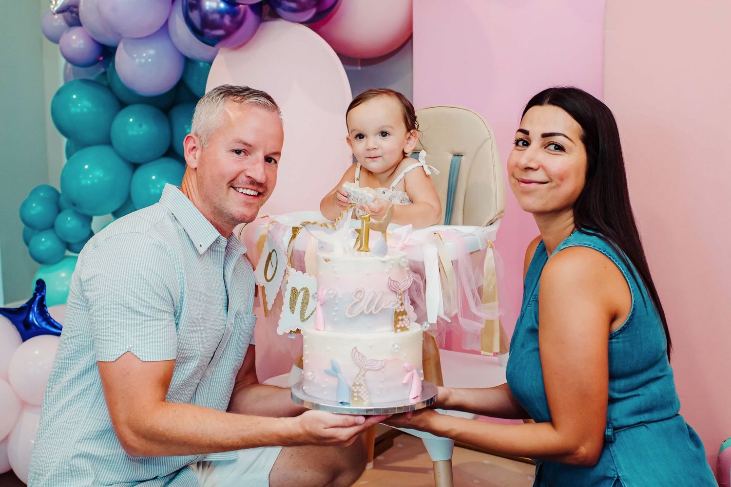 Gender reveal party scene with blue and pink balloon decorations and cake.