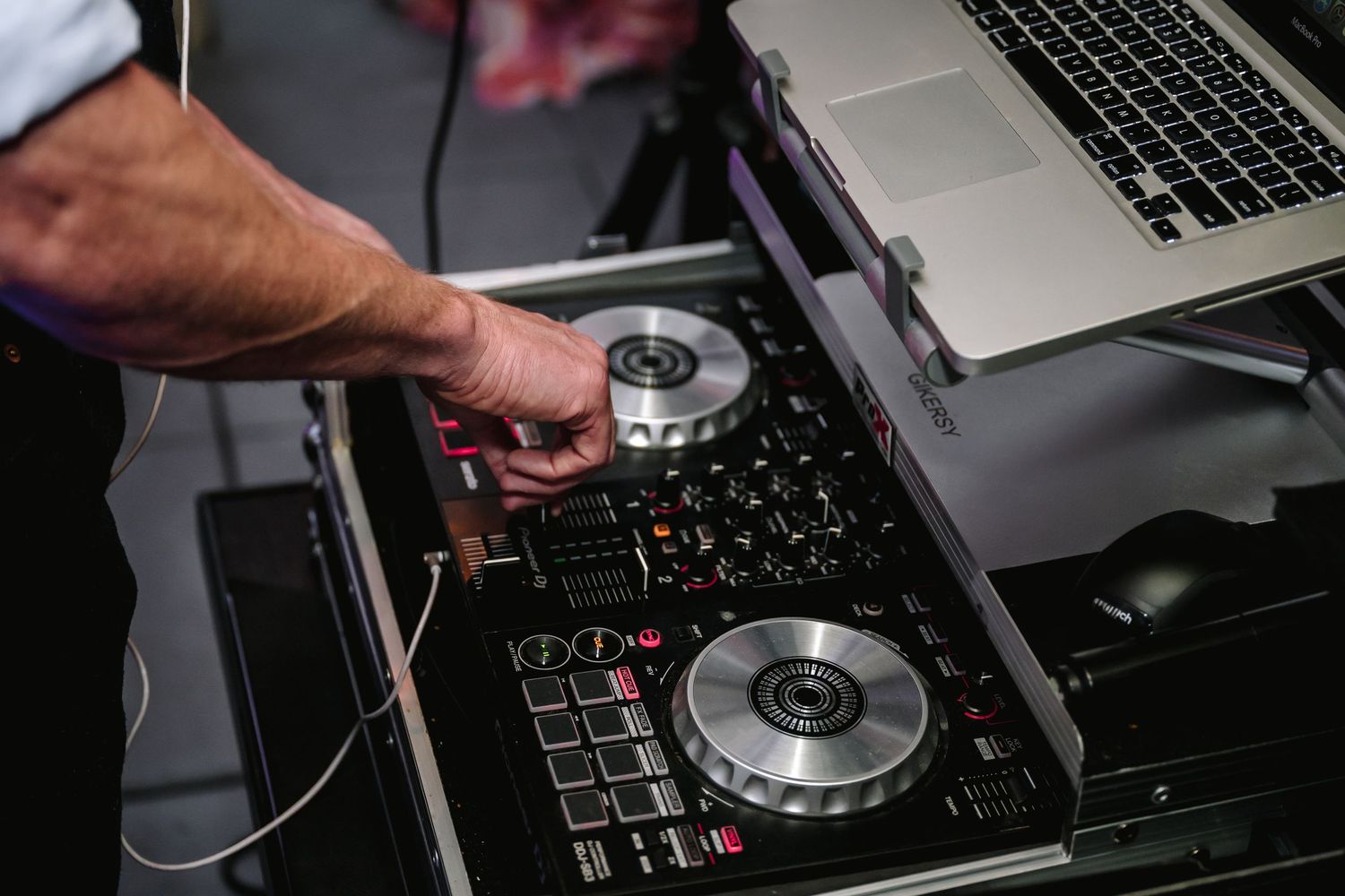 Modern DJ controller and laptop setup being used during a performance.