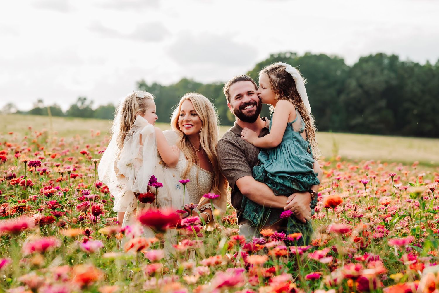 Family enjoying playful moments together in blooming red poppy field.