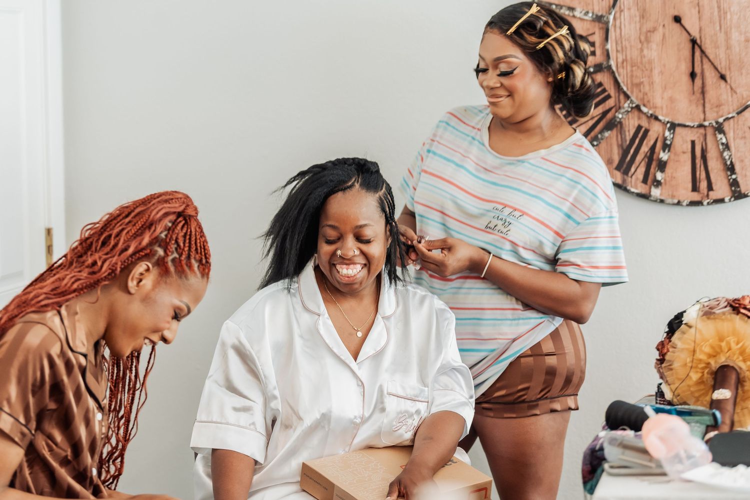 Family and friends celebrate while getting the bride ready for her wedding.