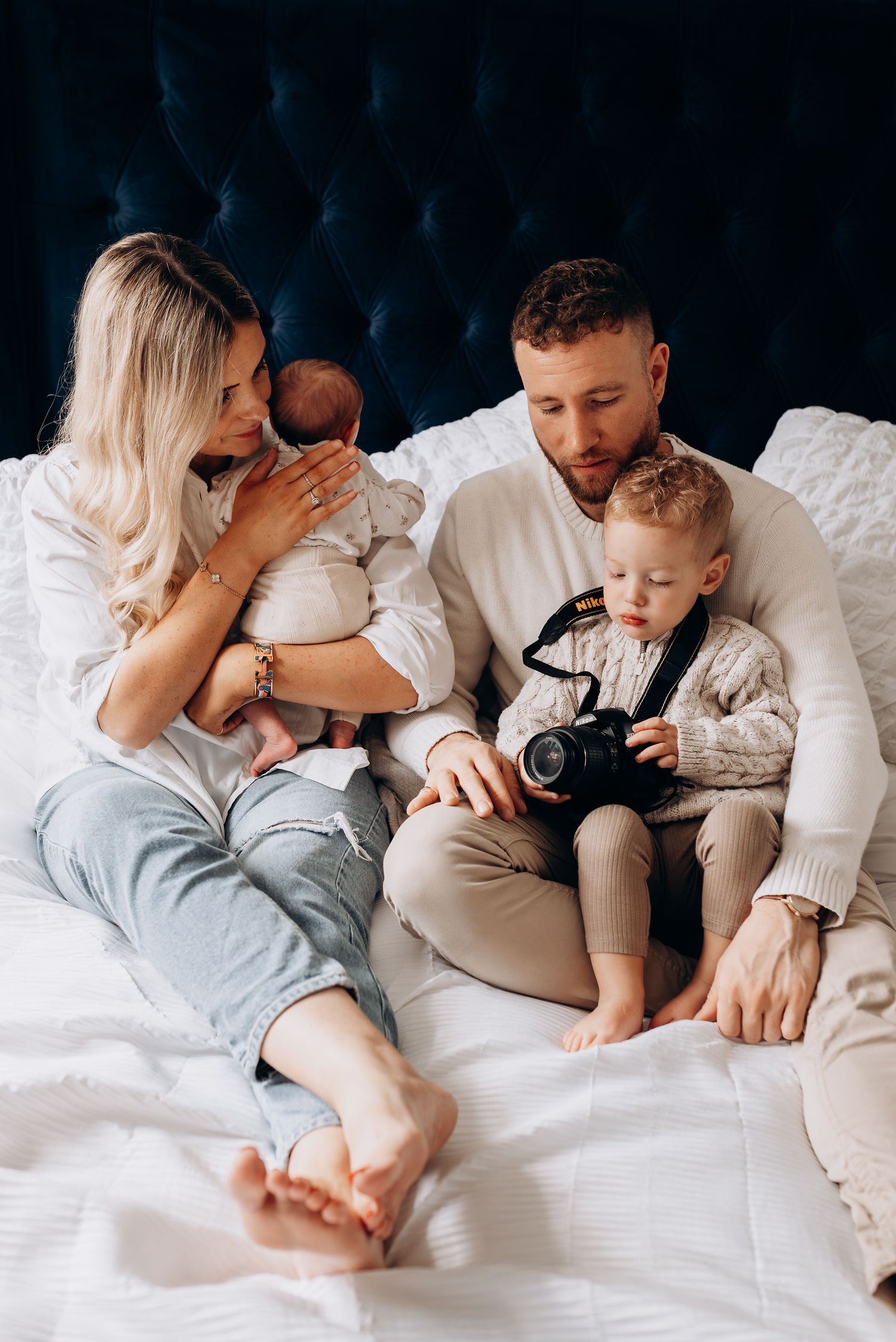 Family lying together on white bedding sharing intimate moments in a series of connected photos.