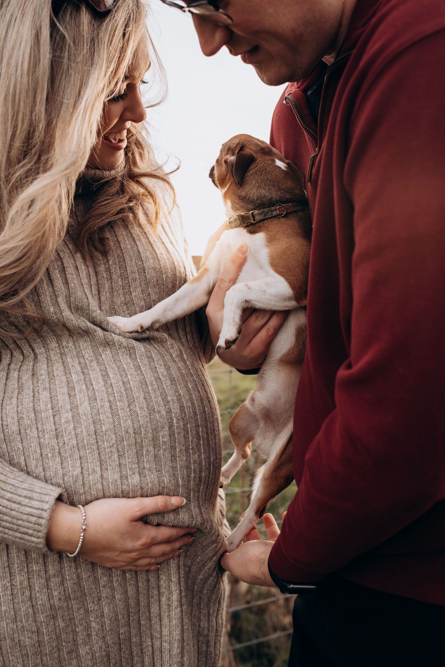 Couple in warm sweaters embracing and sharing intimate moments outdoors.