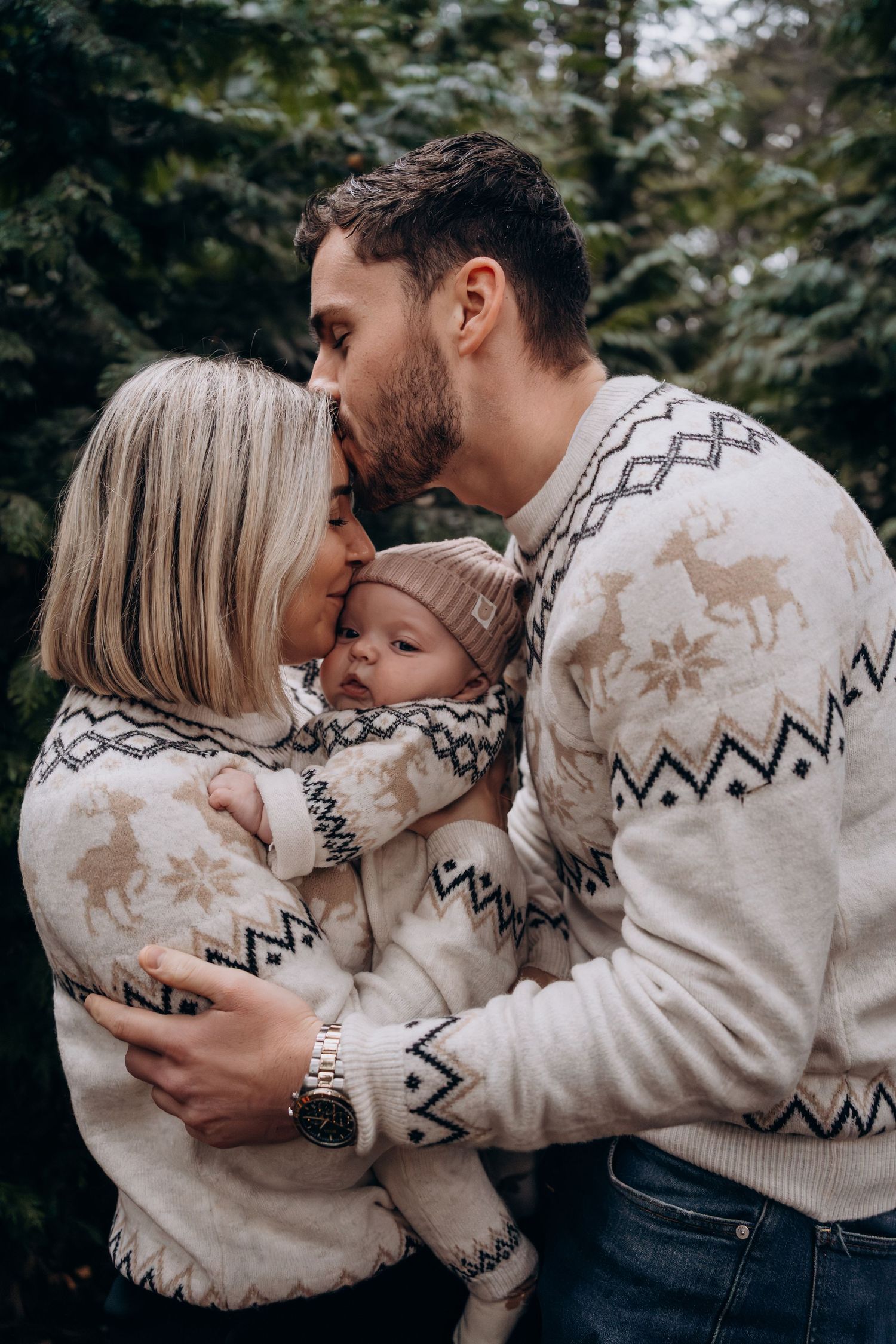A couple in matching winter sweaters share tender moments in a series of romantic outdoor photos.