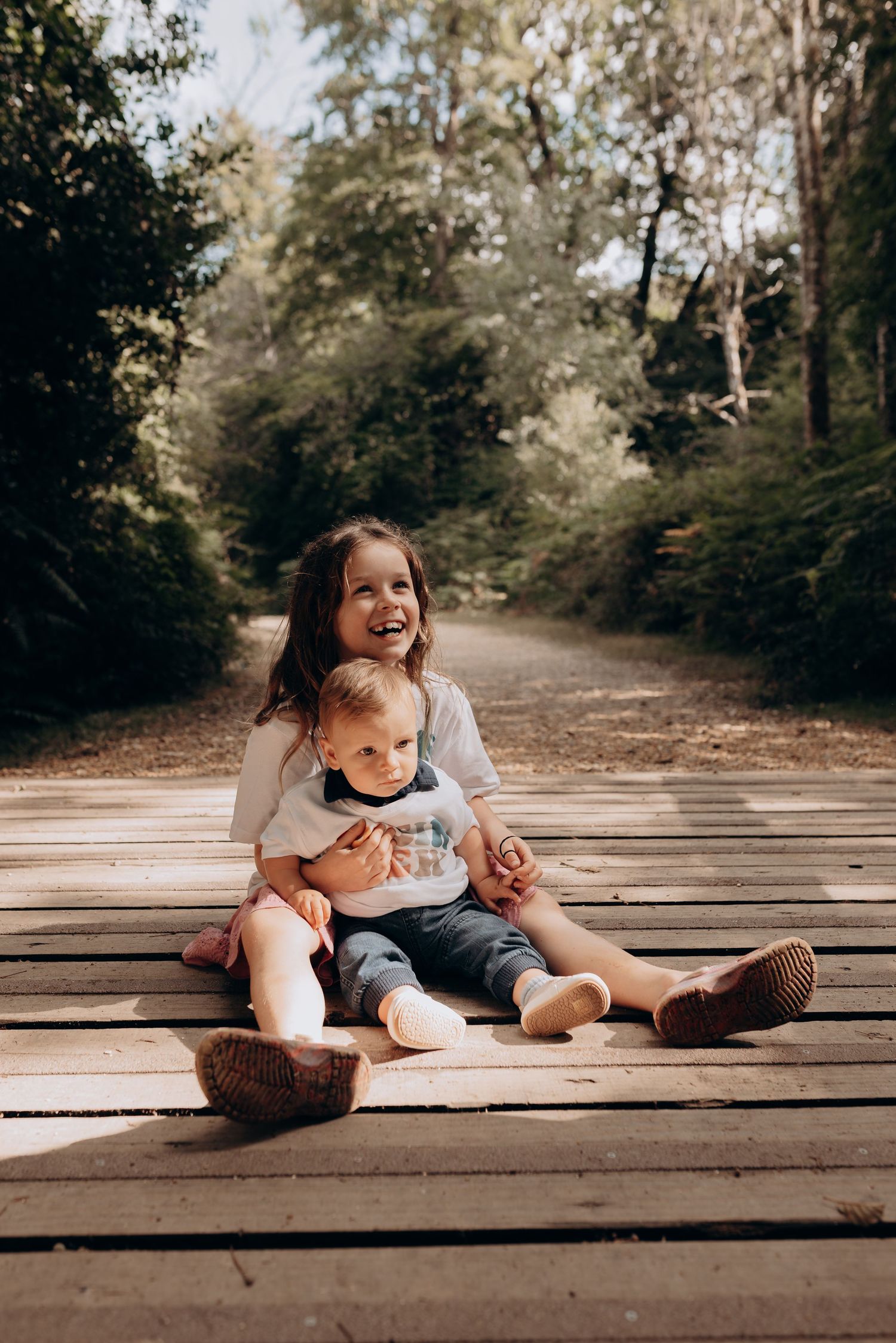 Candid moments of joy shared between parent and child on wooden deck.