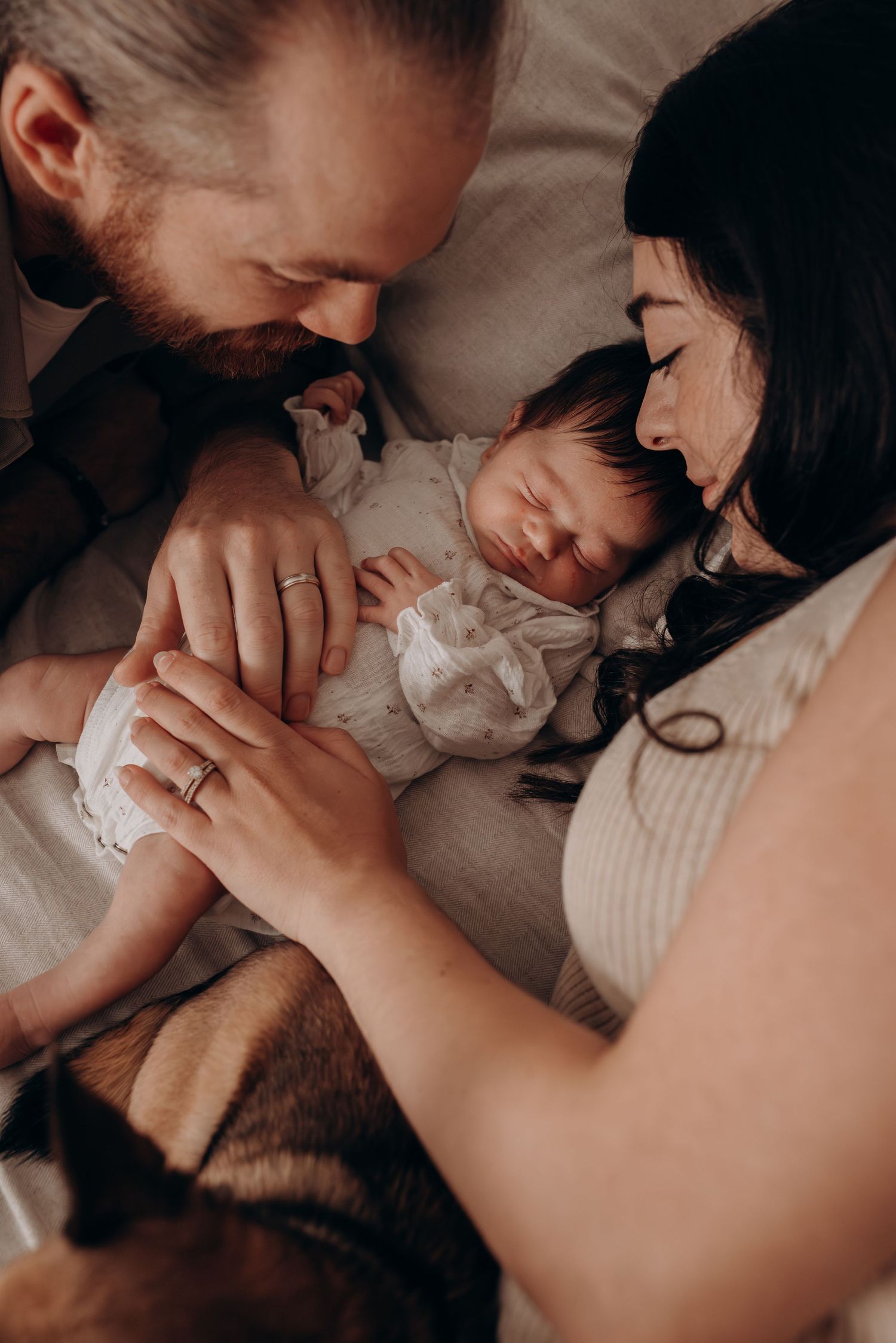 Intimate close-up photo series showing tender moments between parent and baby in soft lighting.