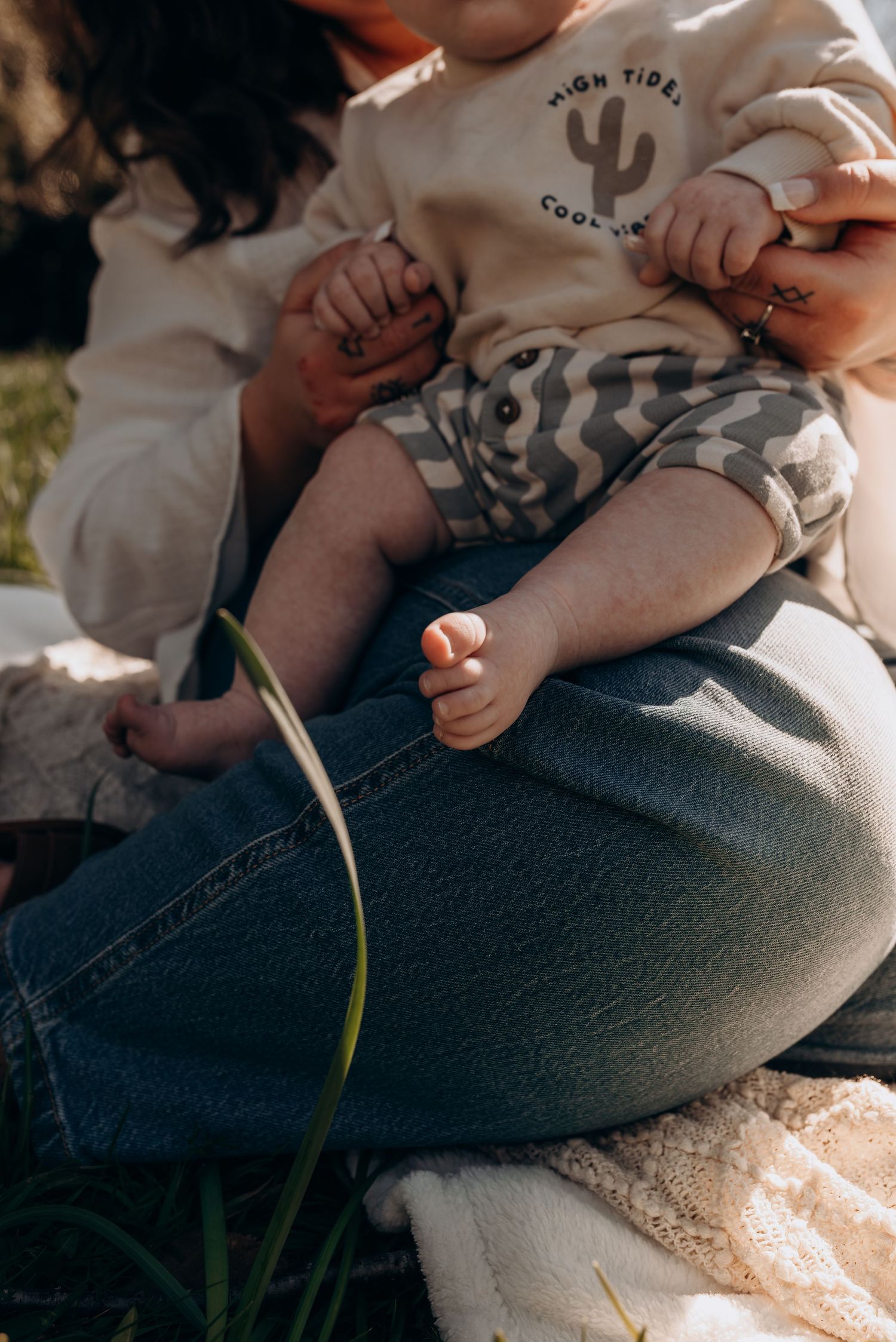 Intimate lifestyle photography session capturing tender family moments outdoors.