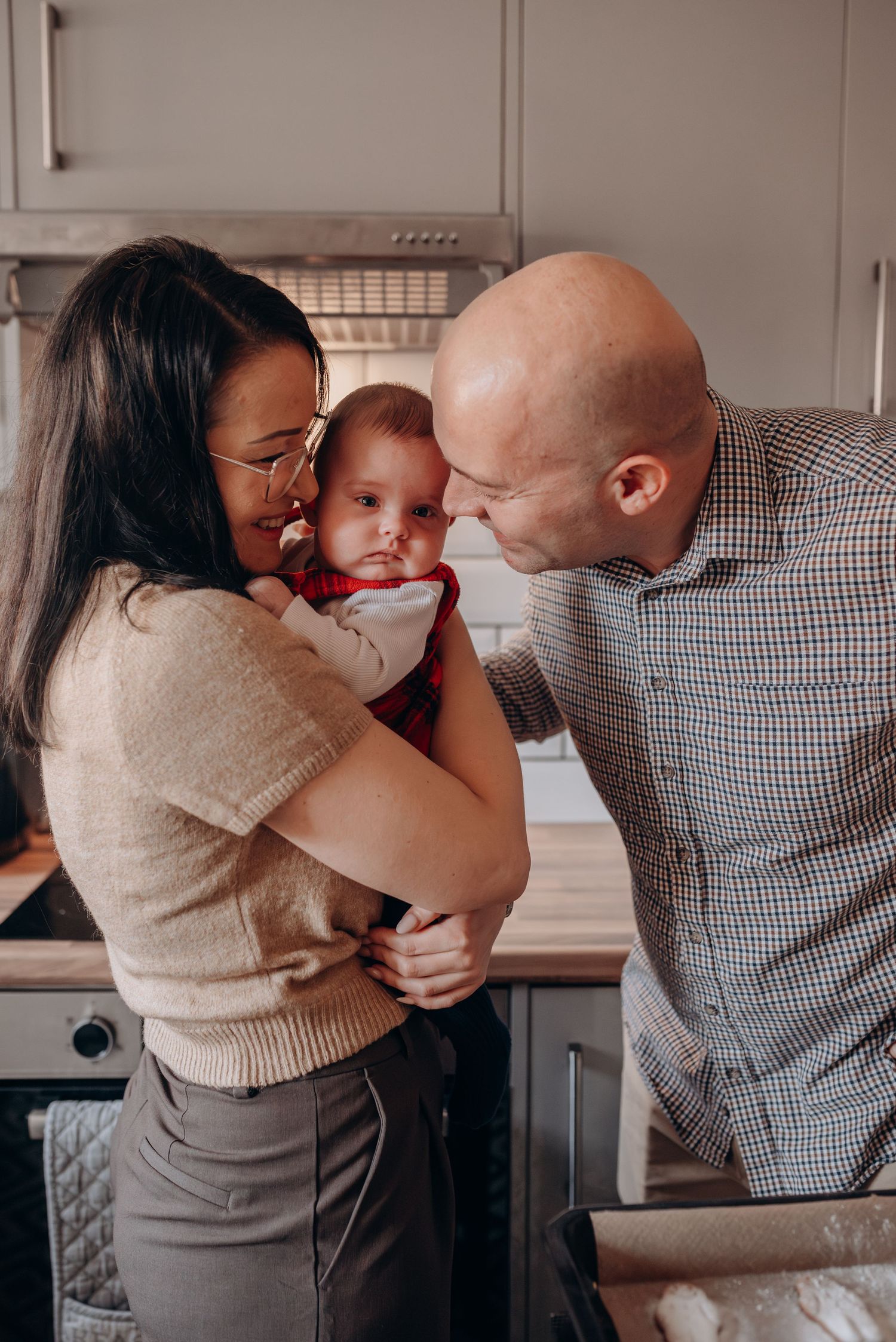 Family sharing an intimate moment together in their kitchen.