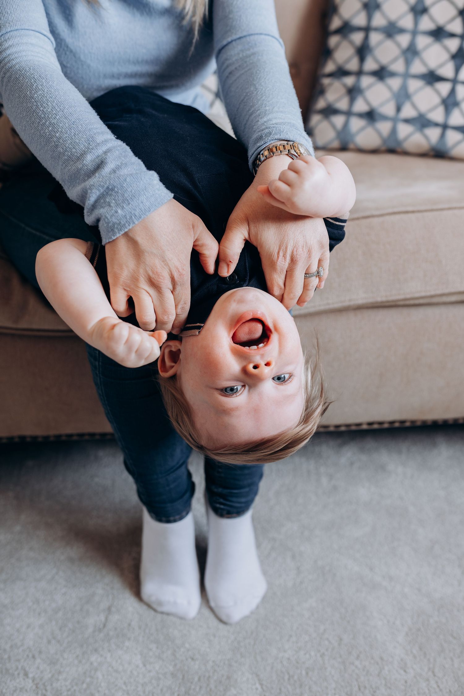 Close-up shots of hands and feet on a cozy gray couch.