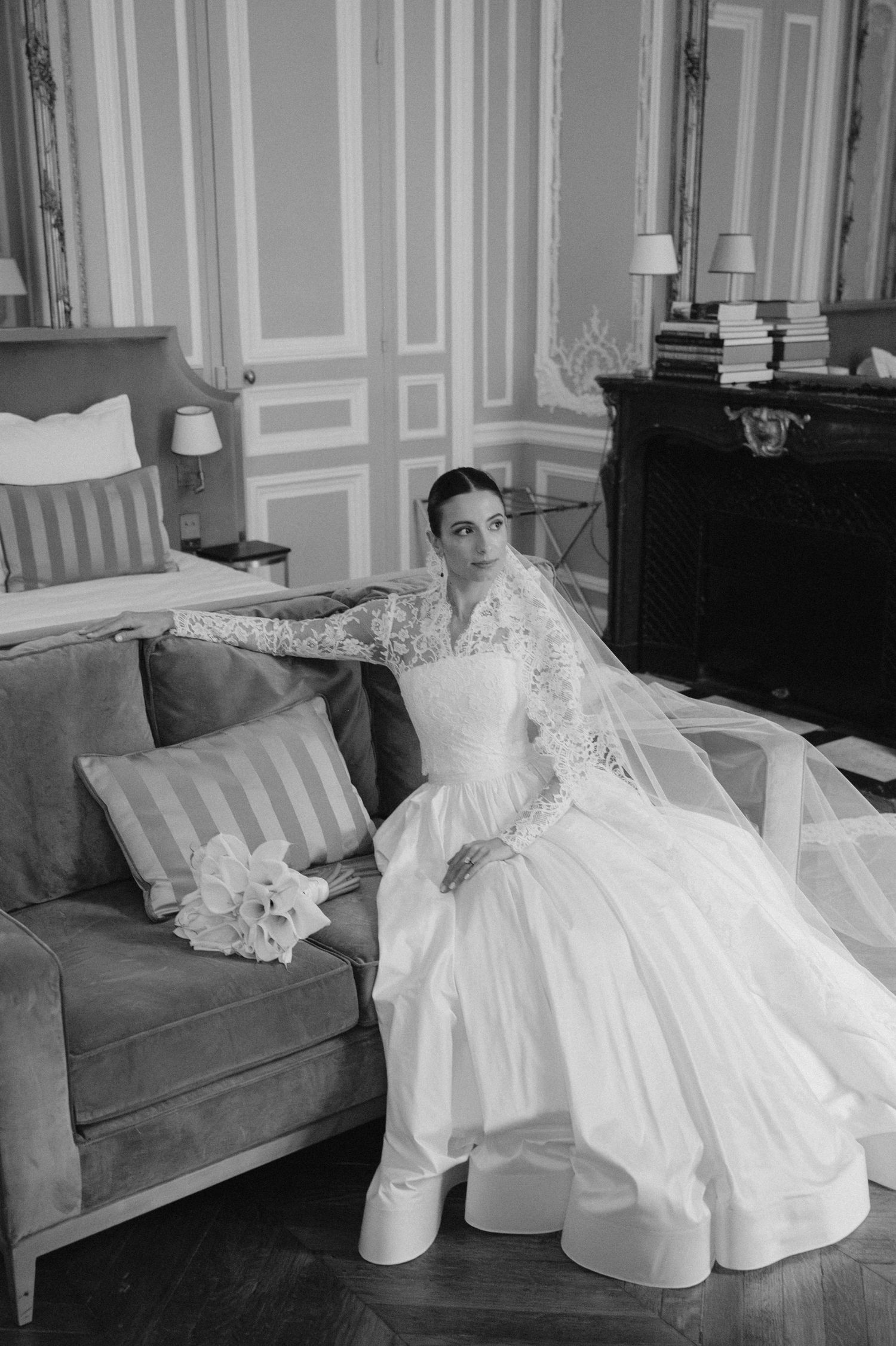 Black and white photos of wedding dress details on vintage furniture in elegant room.