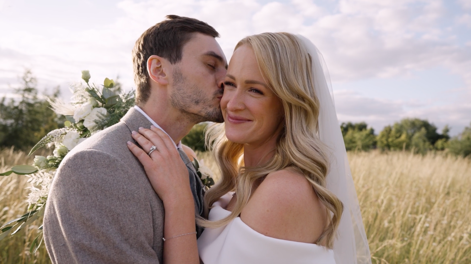 A romantic couple shares intimate moments in a golden wheat field during sunset.