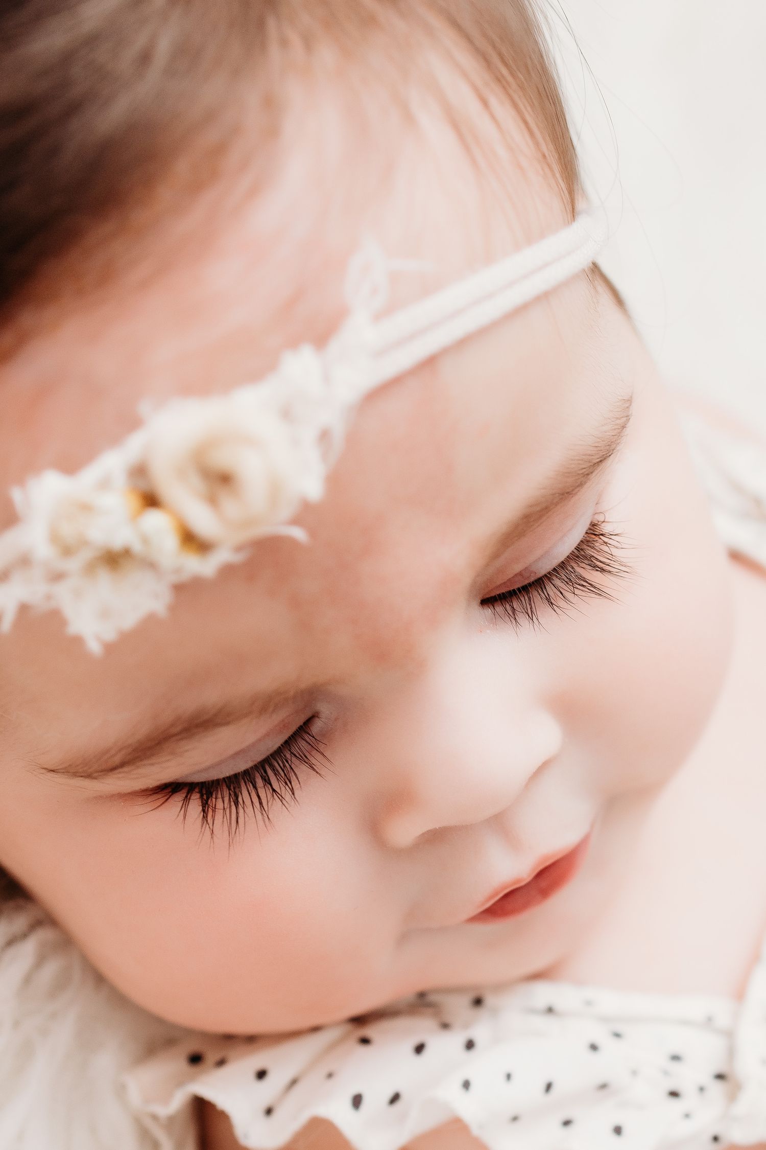 Close up photo of baby's eyelashes during her milestone baby photo by Santa Fe photographer. Serving Los Alamos families