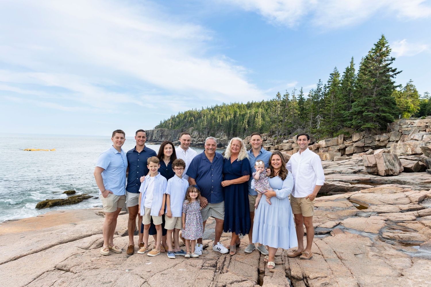 Extended family standing together during a family portrait session in Acadia national park.