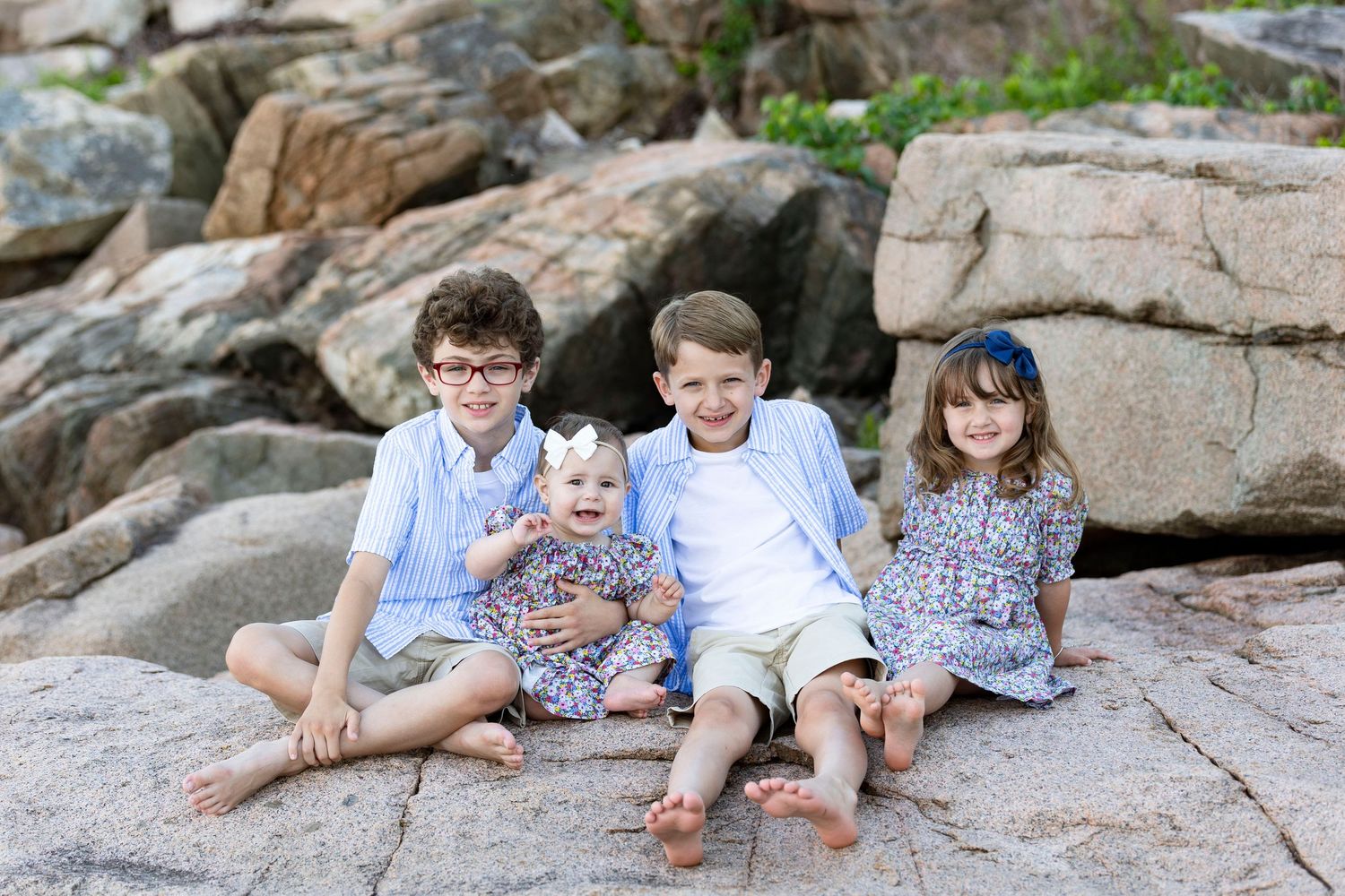 cousins sitting together during a family portrait session in Acadia national park.