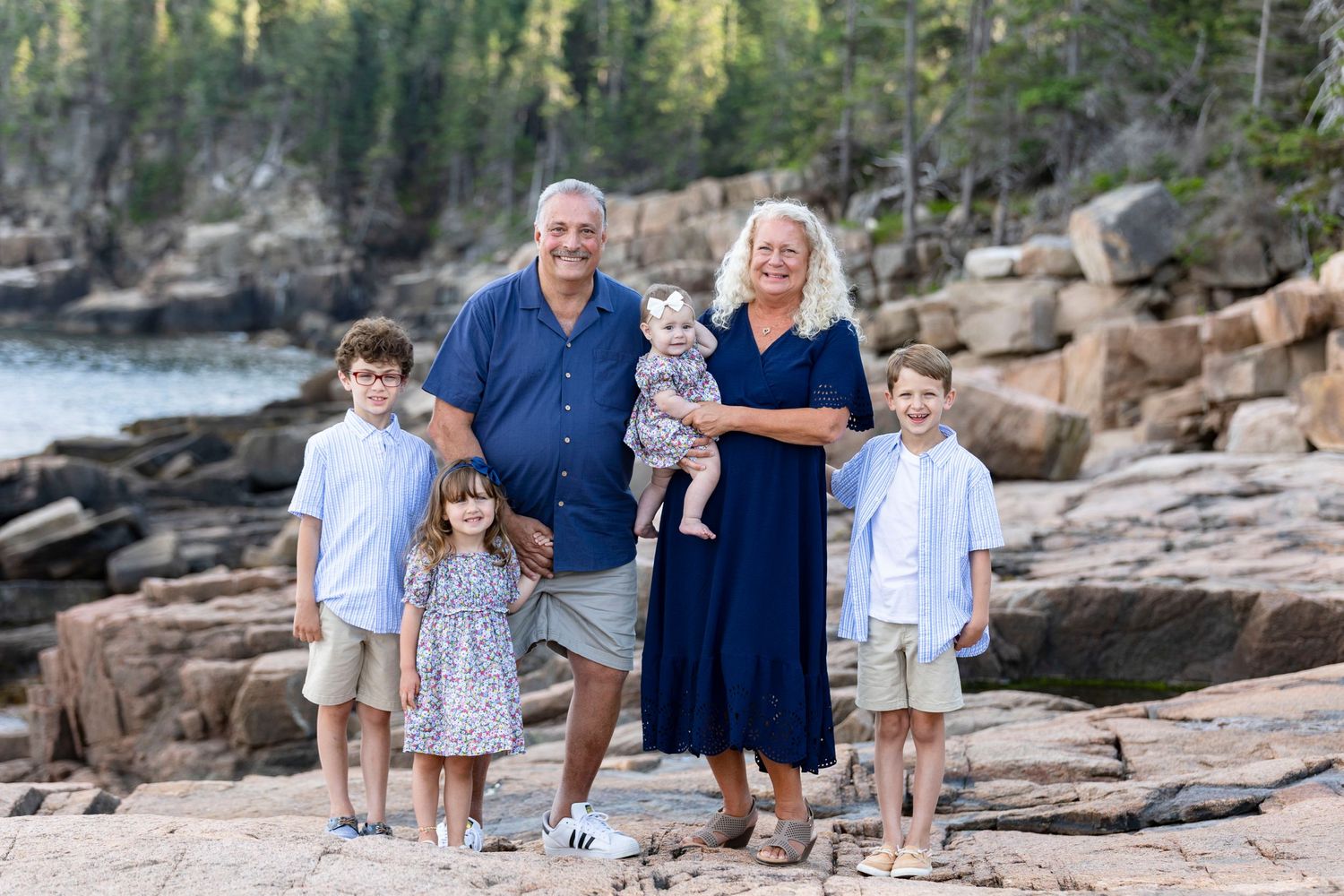 A family together during a family portrait session in Acadia national park.