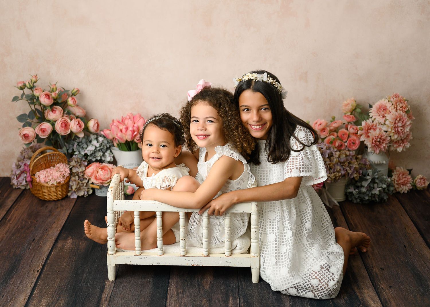 Family portrait session with vintage lace dresses and romantic floral backdrop.
