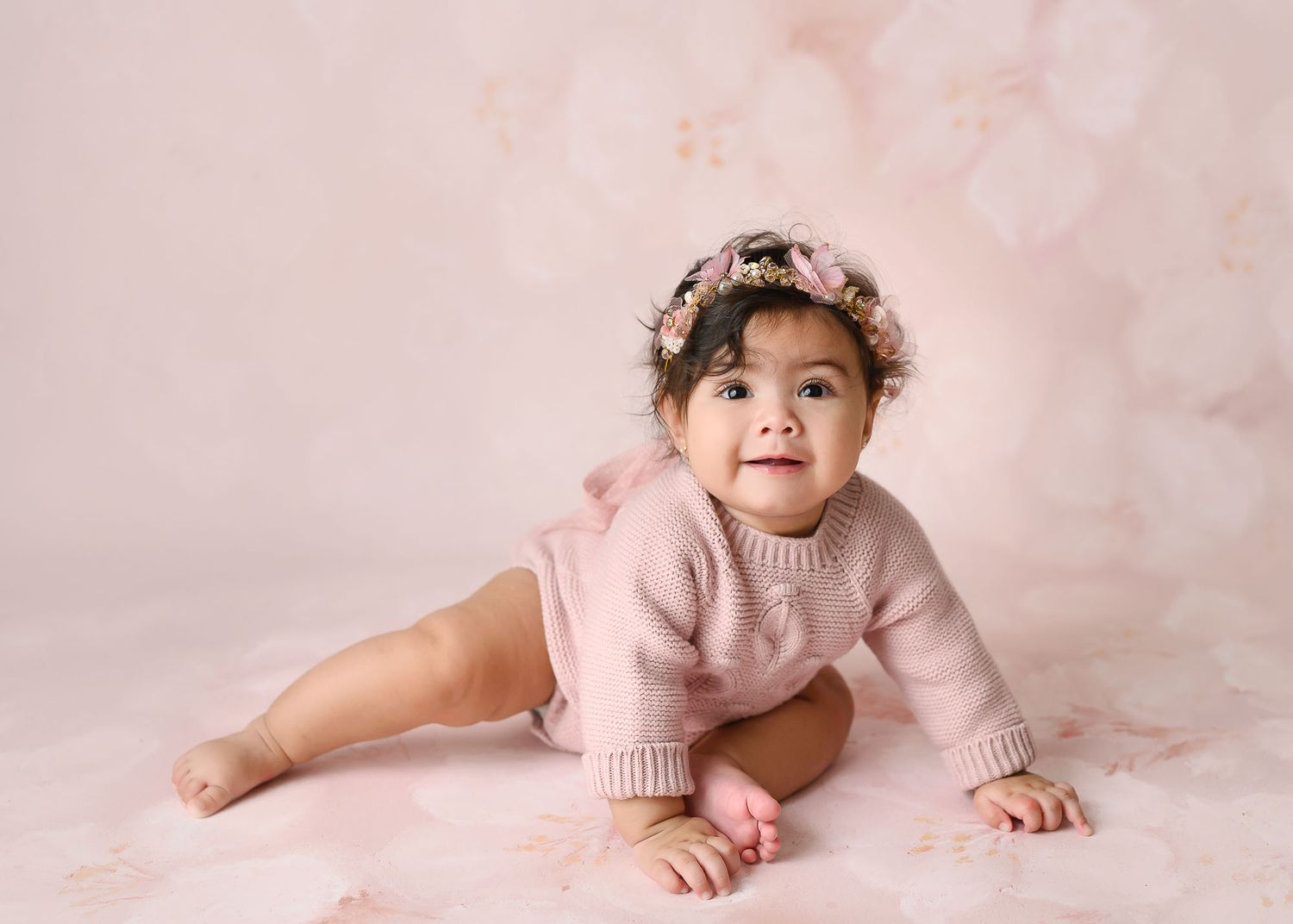 Baby photography collection with pink backdrop showing crawling and sitting poses.