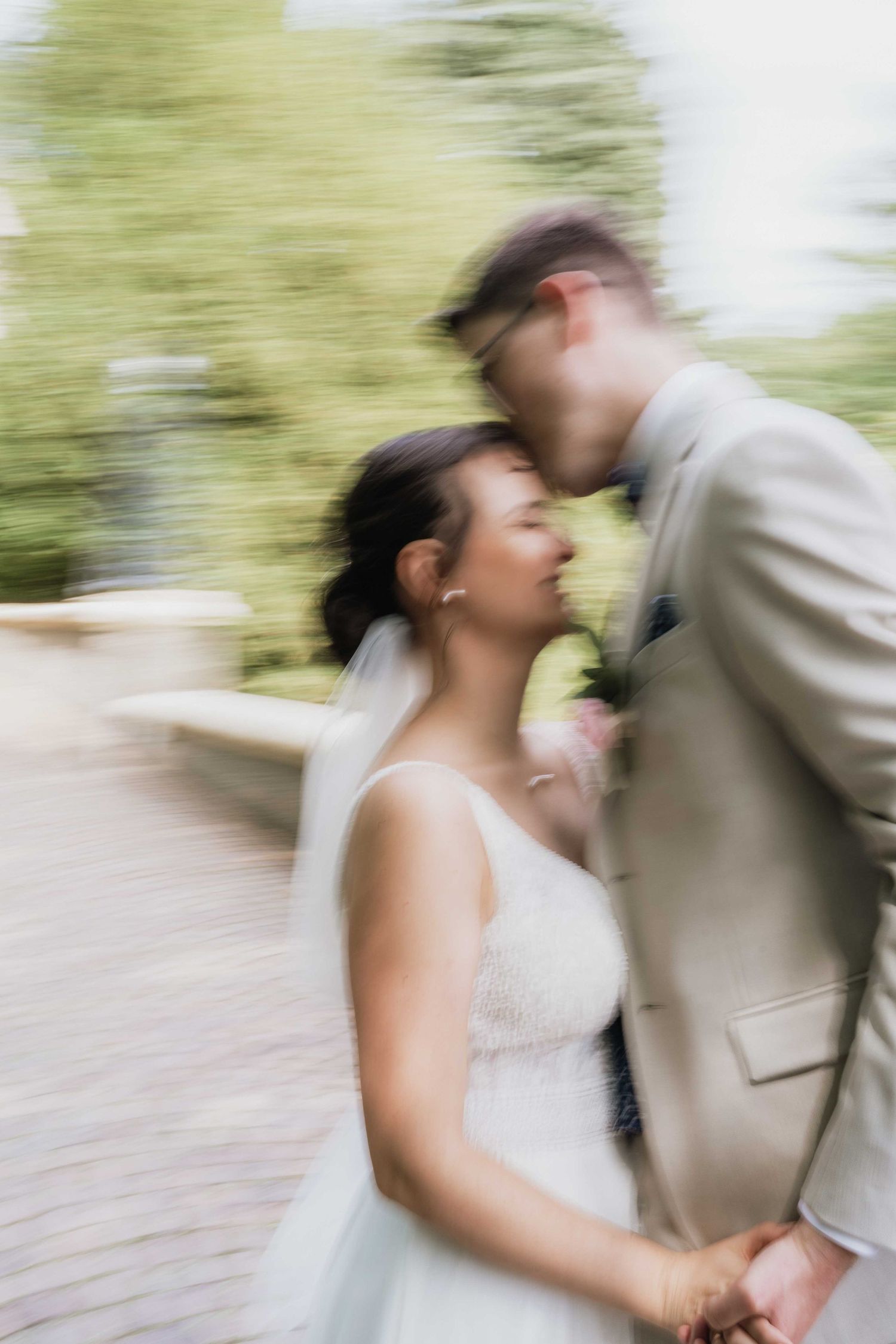 A blurred motion shot captures a romantic dance moment during a wedding celebration.
