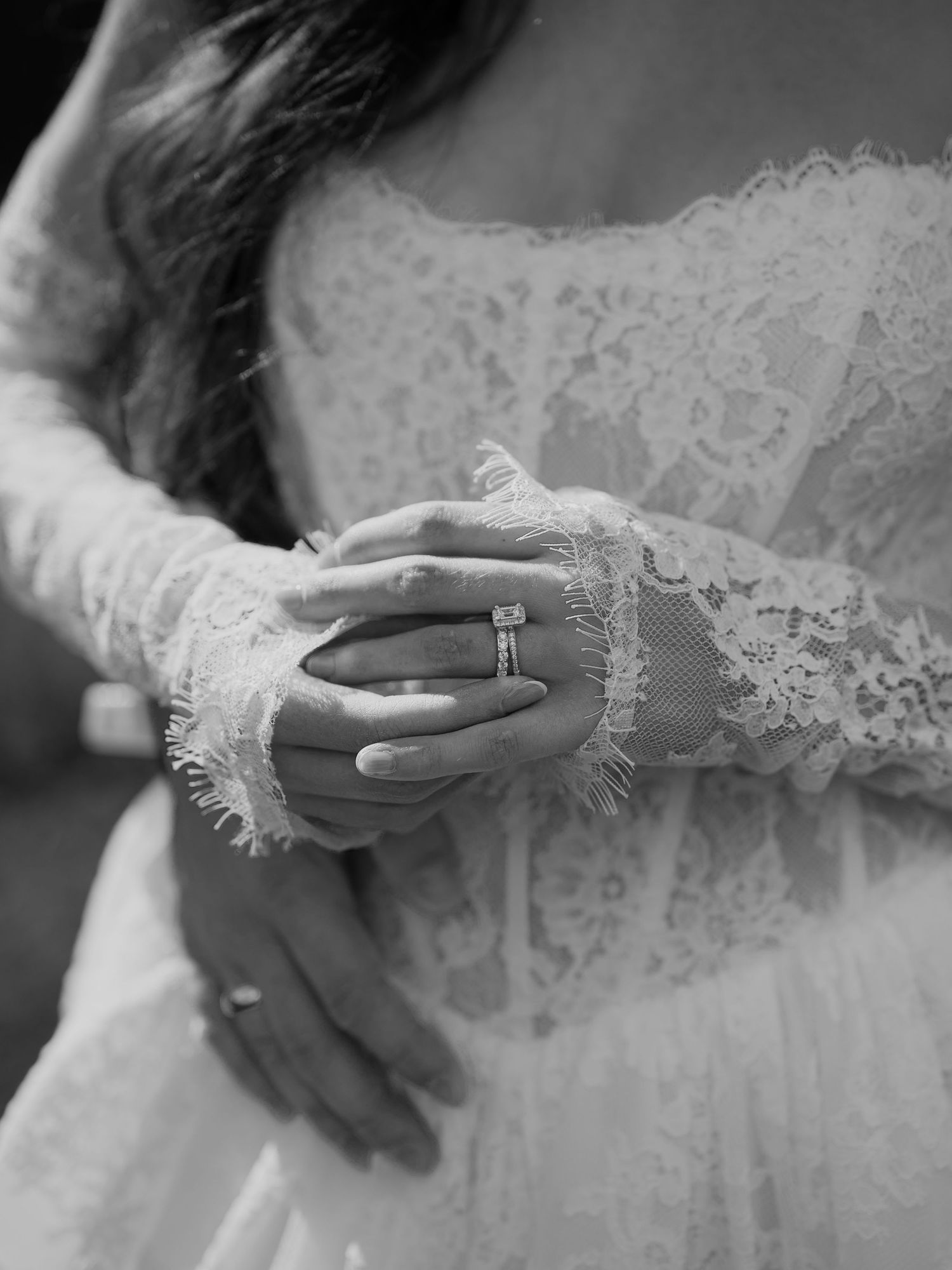 A series of black and white photos showing elegant lace sleeves and wedding rings in different poses.