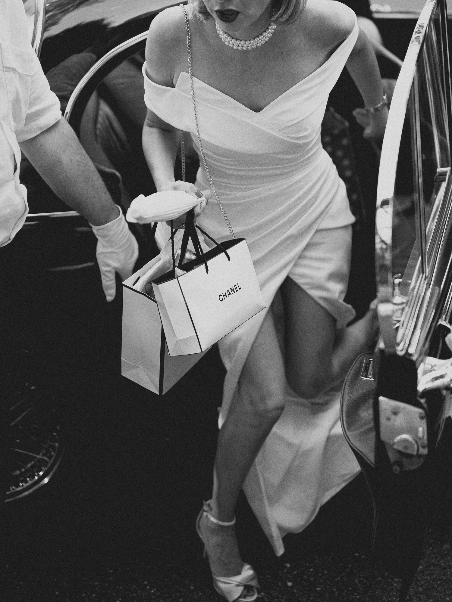 Black and white photo of wedding guests dancing and celebrating at a reception.