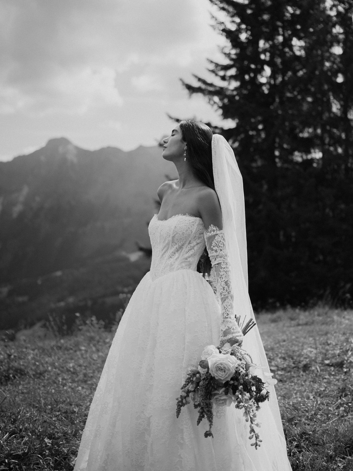 A series of black and white wedding dress photos showing delicate lace details against a mountainous backdrop.